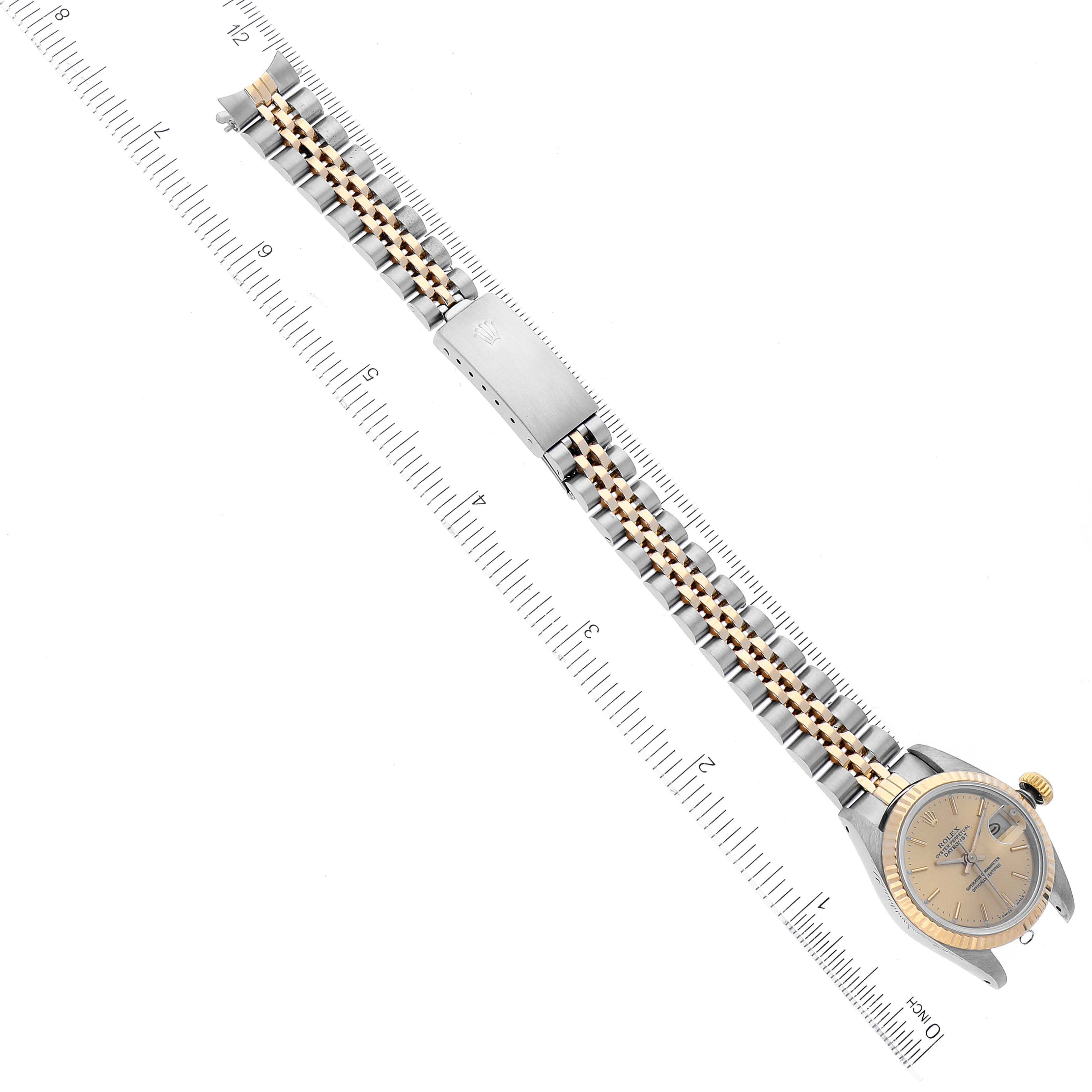 The image shows a Rolex Datejust 69173 Women's Steel and Gold (two tone) Champagne Dial 69173 Women's Steel and Gold (two tone) Champagne Dial watch laid flat with the bracelet extended, alongside a ruler for size reference.