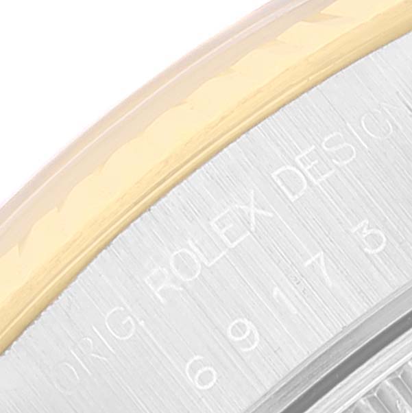 The image shows a close-up of the side engraving and bezel of a Rolex Datejust 69173 Women's Steel and Gold (two tone) Grey Dial 69173 Women's Steel and Gold (two tone) Grey Dial watch.