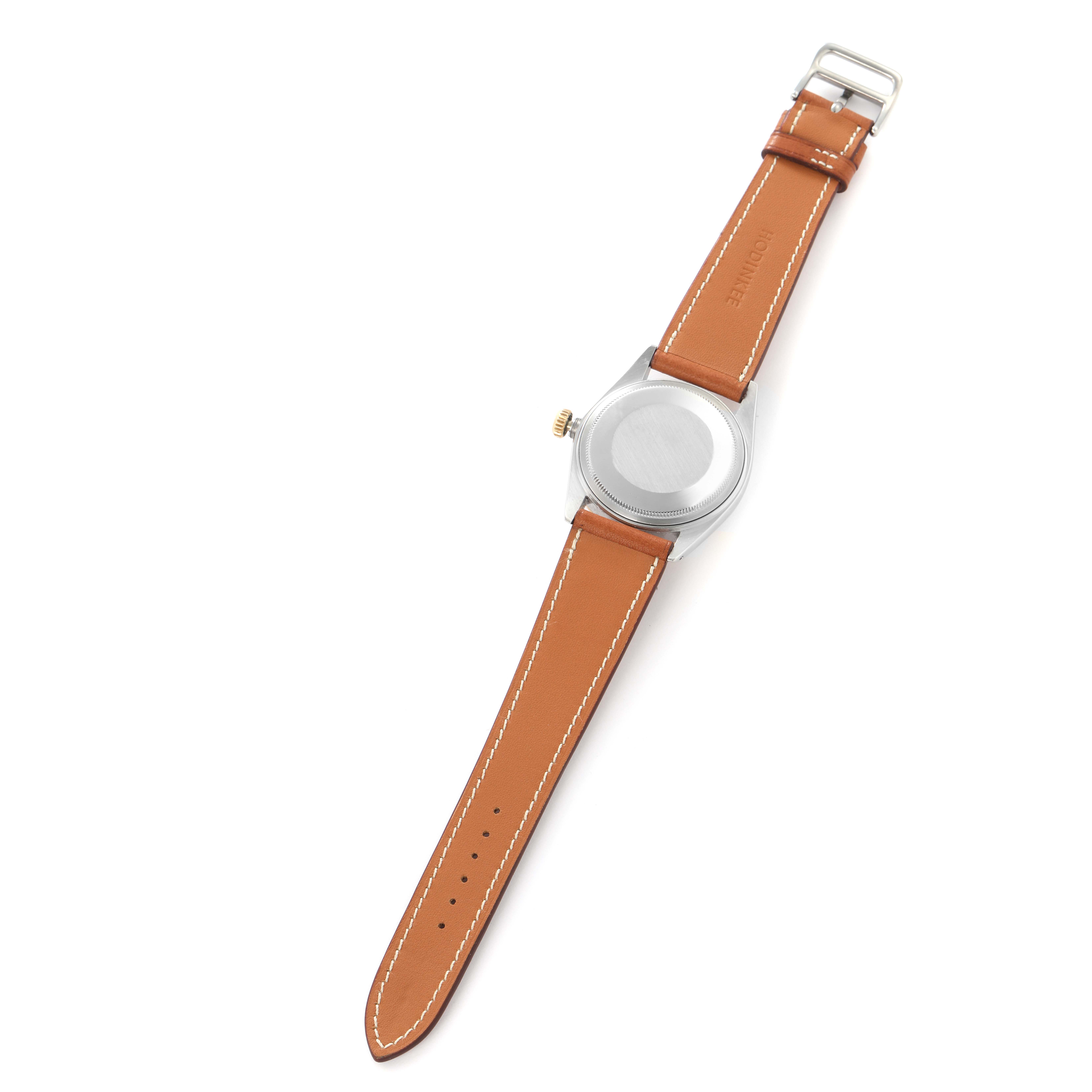 The image shows the back of a Rolex Vintage Collection watch, model number 16013, with the leather strap fully extended and the case back visible.