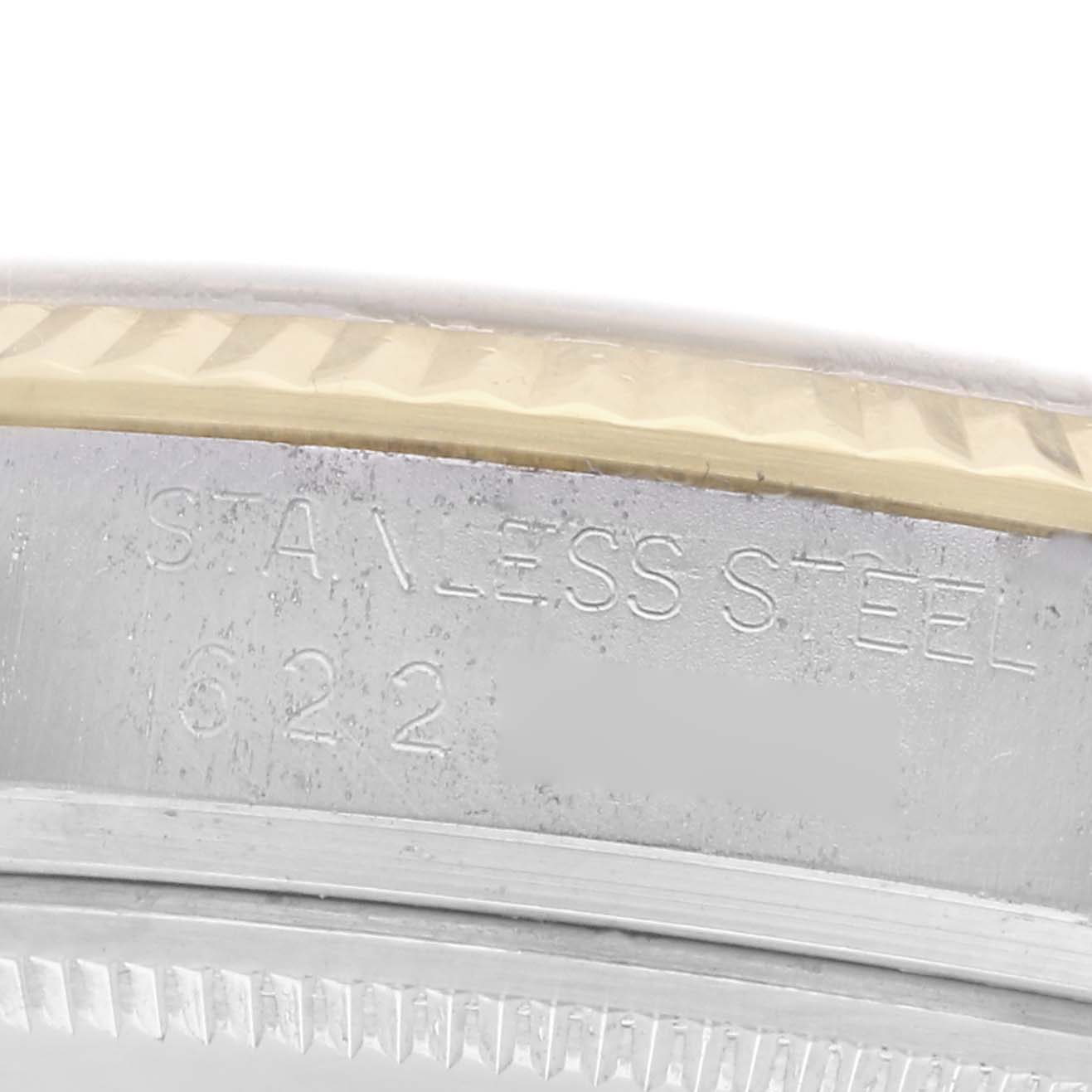 The image shows a close-up of the case edge of the Rolex Vintage Collection model 16013 men's watch, highlighting the stainless steel engraving and fluted bezel.
