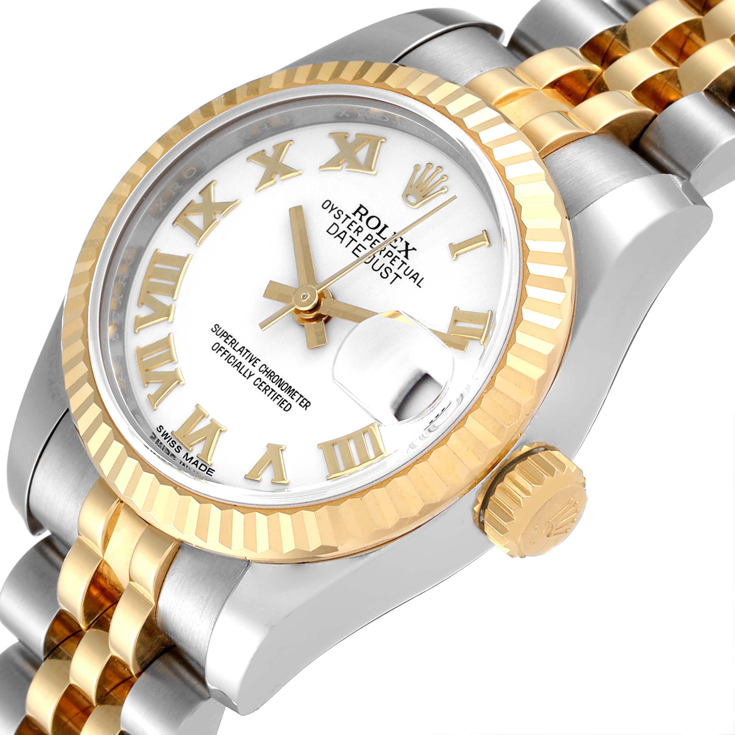 The image shows a close-up view of a Rolex Datejust 179173 Women's Steel and Gold (two tone) White Dial 179173 Women's Steel and Gold (two tone) White Dial's face, bezel, crown, and part of its jubilee bracelet.