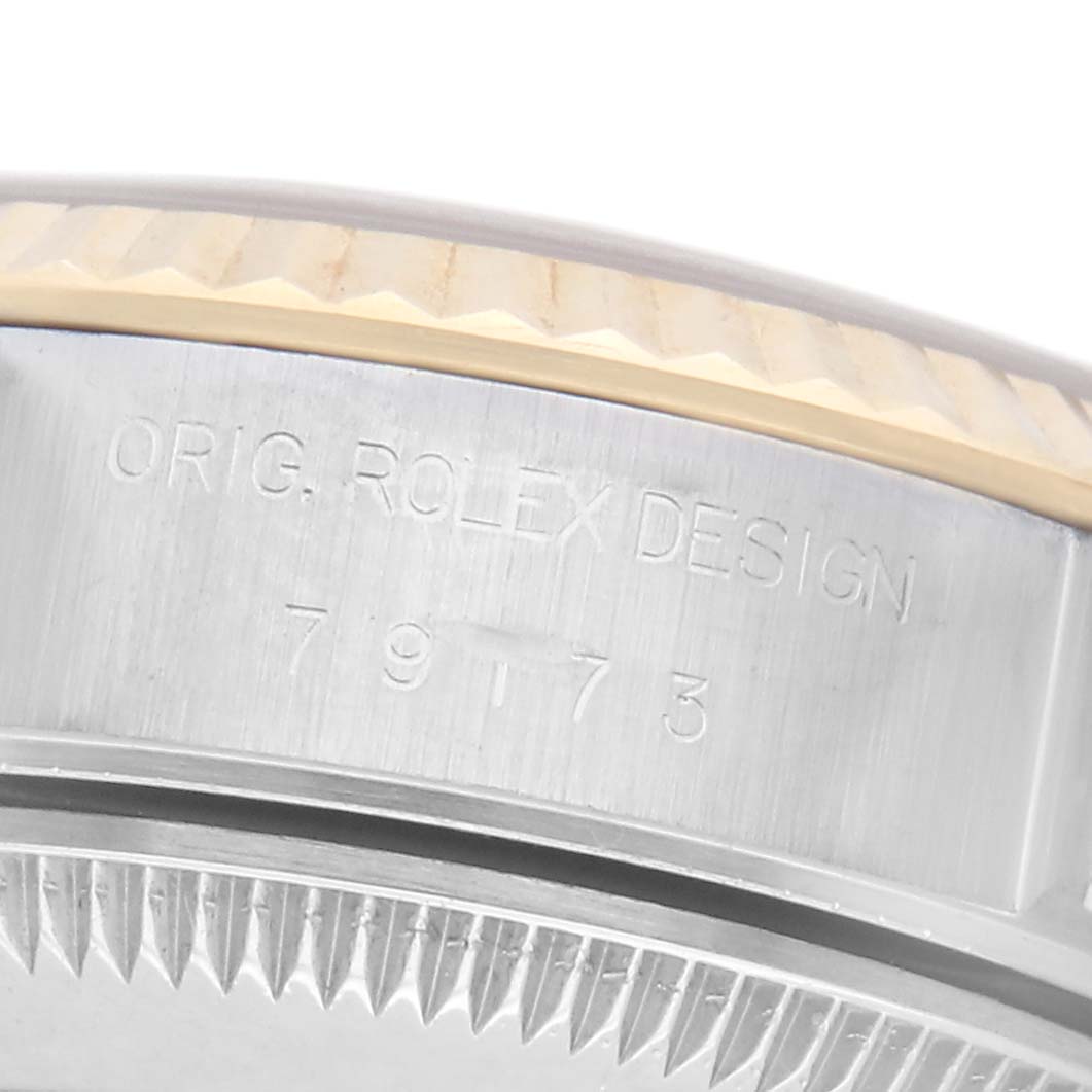 The image shows the side view of a Rolex Datejust model 79173, focusing on the engraved model number and part of the case edge.
