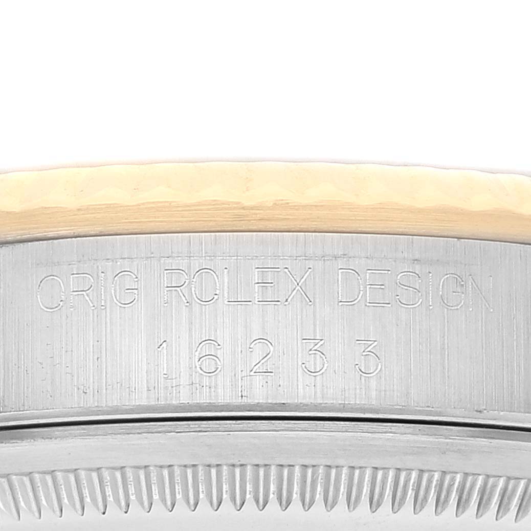 The image shows a close-up of the model number and design engraving on the casing of a Rolex Datejust 16233 Men's Steel and Gold (two tone) White Dial 16233 Men's Steel and Gold (two tone) White Dial watch.