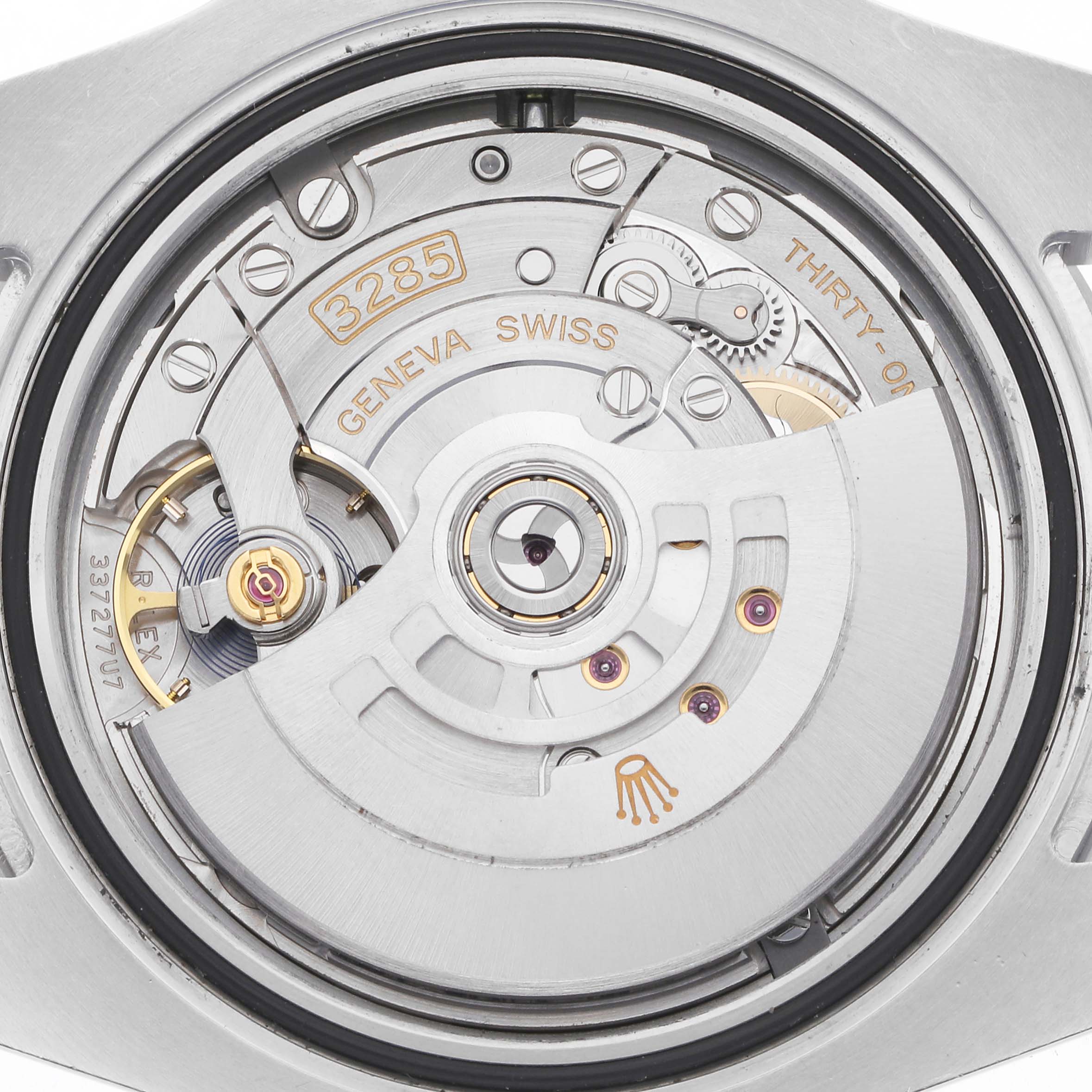 The image shows the movement of a Rolex GMT-Master model 126710, focusing on the intricate mechanical parts from the back angle.