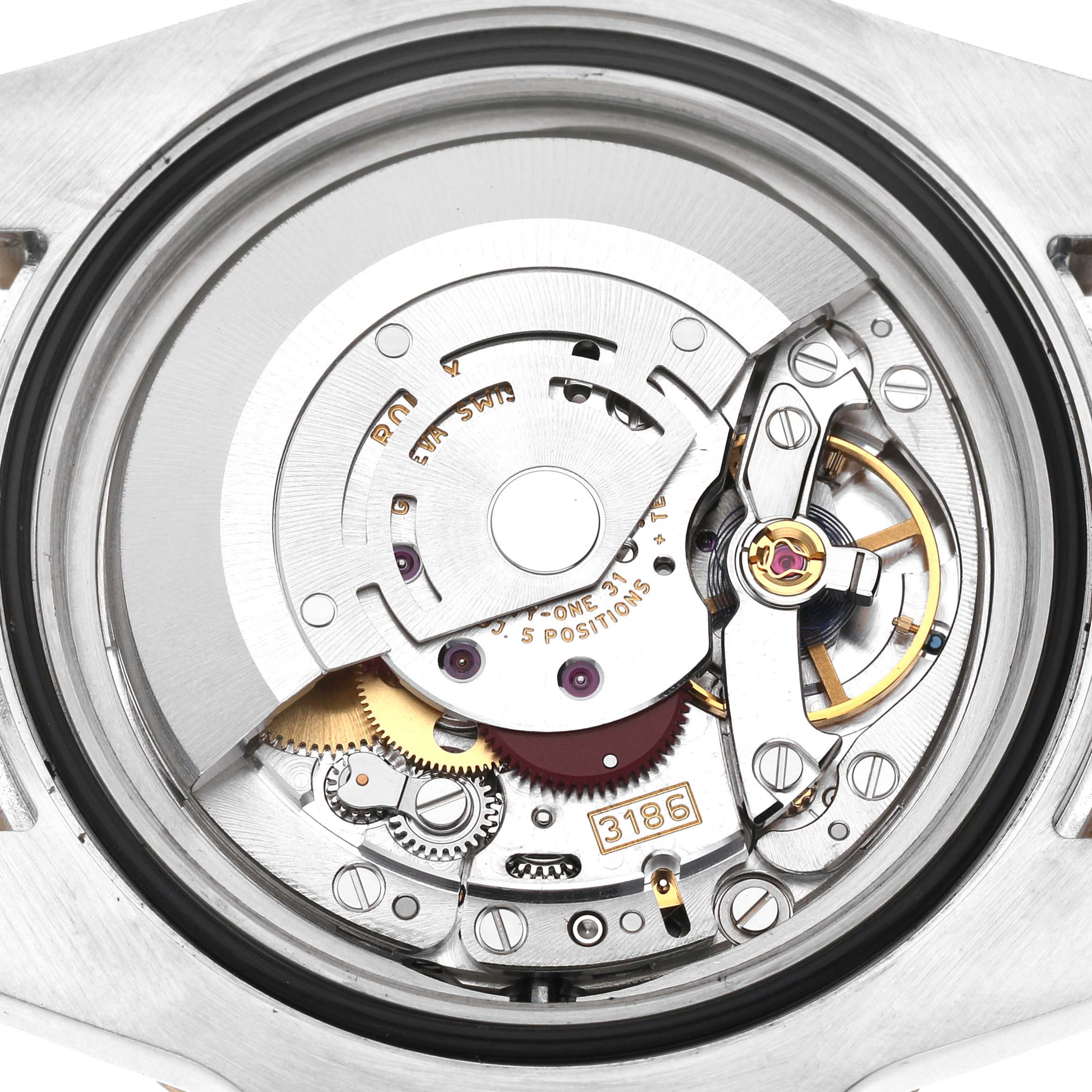 The image shows the movement of a Rolex GMT-Master 116713LN Men's Stainless Steel Black Dial watch from a top-down angle, highlighting its intricate mechanical parts.