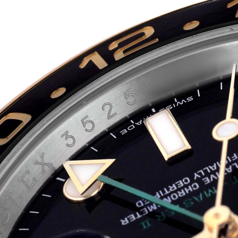 The image shows a close-up of the Rolex GMT-Master 116713LN Men's Stainless Steel Black Dial's bezel and part of the dial, including the hands and some hour markers.