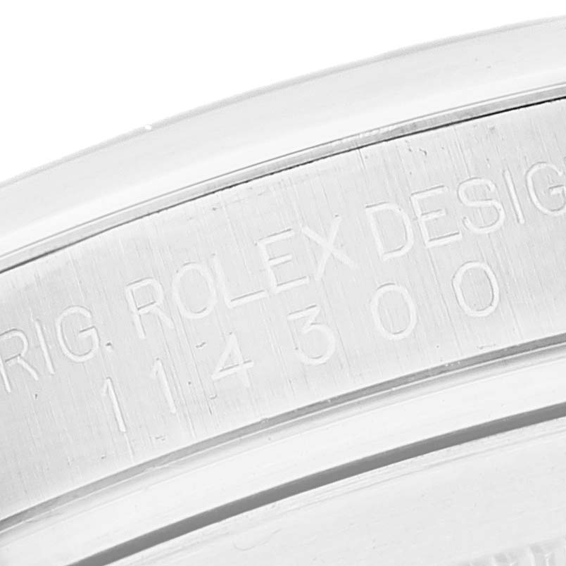 This image shows the serial engraving on the side of a Rolex Oyster Perpetual 114300 Men's Stainless Steel Grey Dial 114300 Men's Stainless Steel Grey Dial watch case.