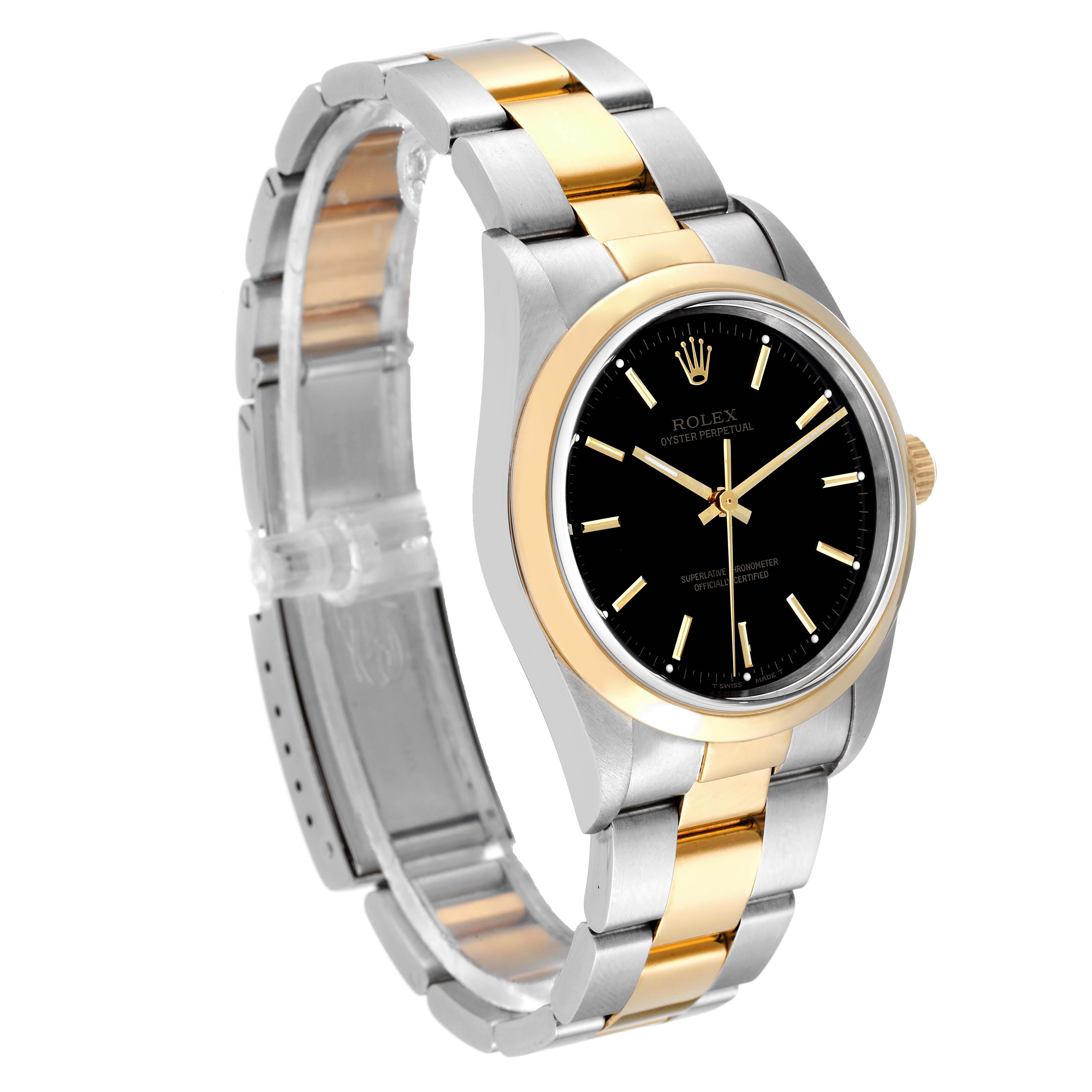 The image shows a Rolex Oyster Perpetual 14203 Men's Steel and Gold (two tone) Black Dial 14203 Men's Steel and Gold (two tone) Black Dial watch at a three-quarter angle, highlighting its two-tone bracelet, black dial, and gold bezel.