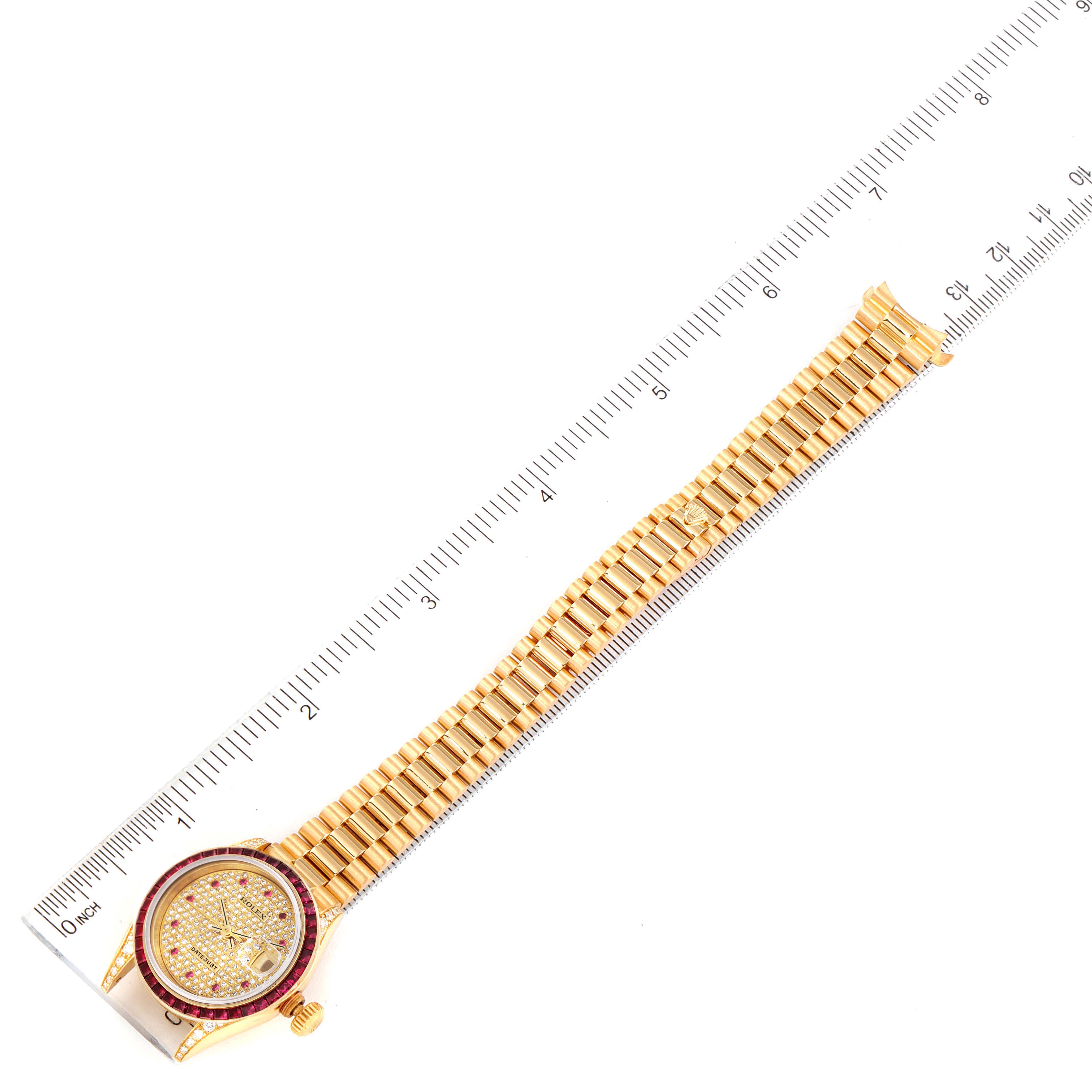 The image shows a Rolex President 69028 Women's Yellow Gold  69028 Women's Yellow Gold  model watch laid flat next to a ruler, displaying the full bracelet and face.