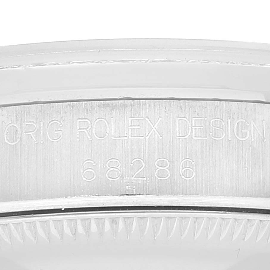 This image shows a close-up of the side of a Rolex President 68286 Women's Platinum Silver Dial 68286 Women's Platinum Silver Dial model watch, highlighting the engraved design and model number.