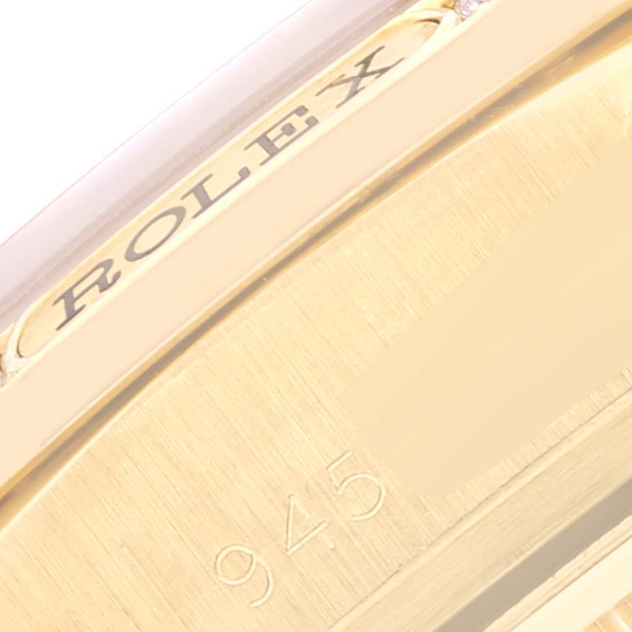 This close-up image shows a partial view of the gold case and engraved markings of a Rolex President 18138 Men's Yellow Gold Champagne Dial 18138 Men's Yellow Gold Champagne Dial model watch.