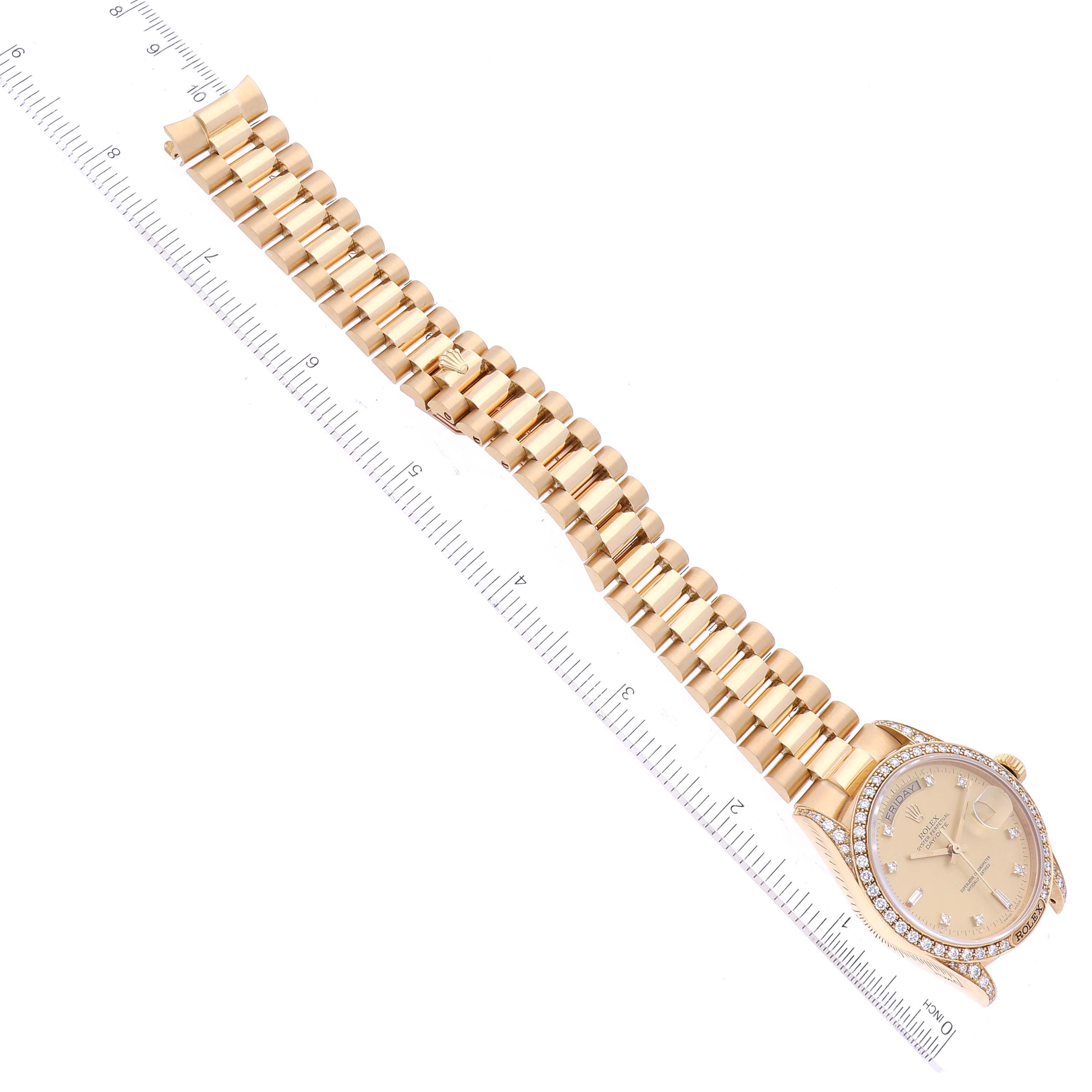 The image shows a Rolex President 18138 Men's Yellow Gold Champagne Dial 18138 Men's Yellow Gold Champagne Dial model watch laid flat next to a ruler, displaying its face and full bracelet.