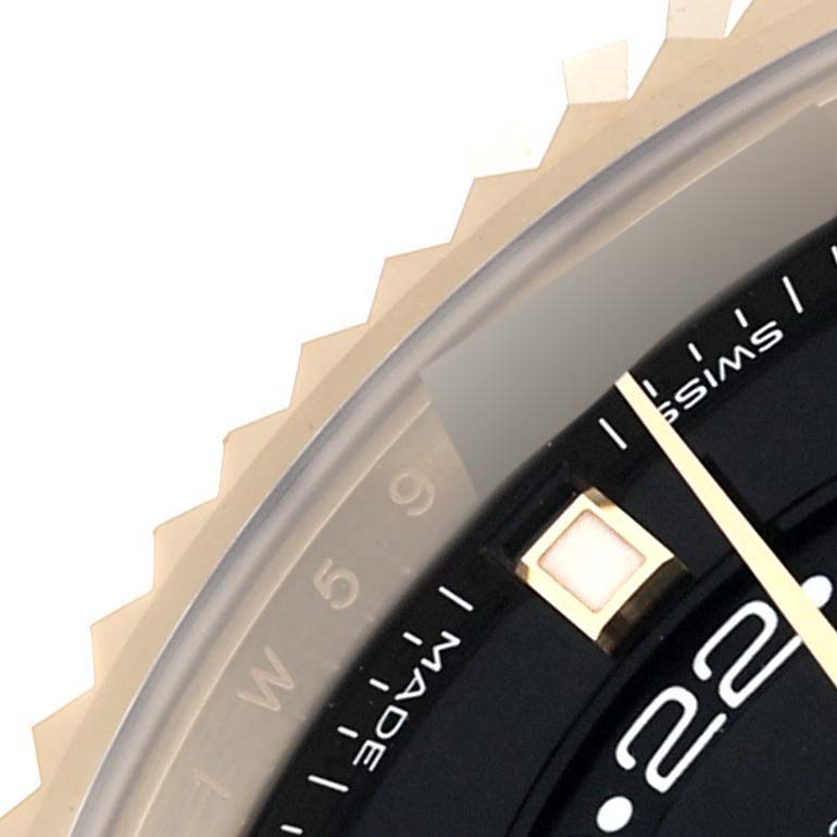 This close-up view of a Rolex Sky-Dweller 326238 Men
s Yellow Gold Black Dial 326238 Men
s Yellow Gold Black Dial watch shows part of the bezel, dial, and the "Swiss Made" inscription.