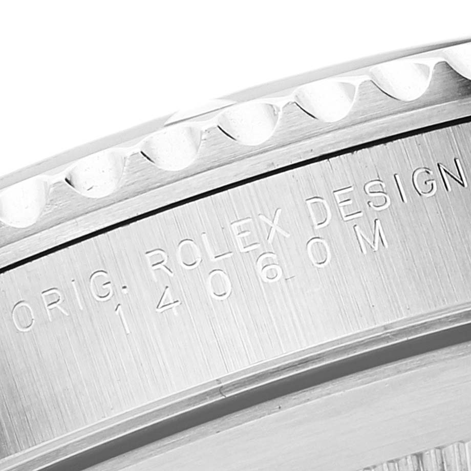 This image shows a close-up of the side engraving on the bezel of a Rolex Submariner 14060 Men's Stainless Steel Black Dial 14060 Men's Stainless Steel Black Dial watch featuring the model number 14060M.