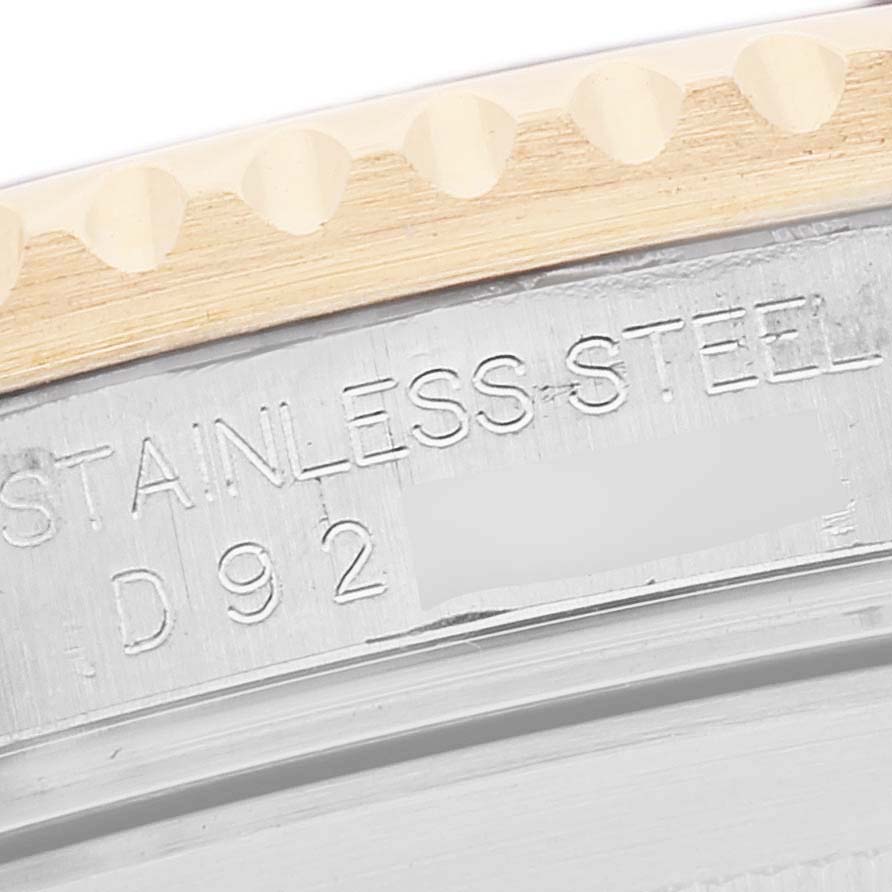The image shows a close-up of the serial number and "STAINLESS STEEL" engraving on the bezel edge of a Rolex Submariner 16613 Men's Steel and Gold (two tone) Blue Dial 16613 Men's Steel and Gold (two tone) Blue Dial watch.