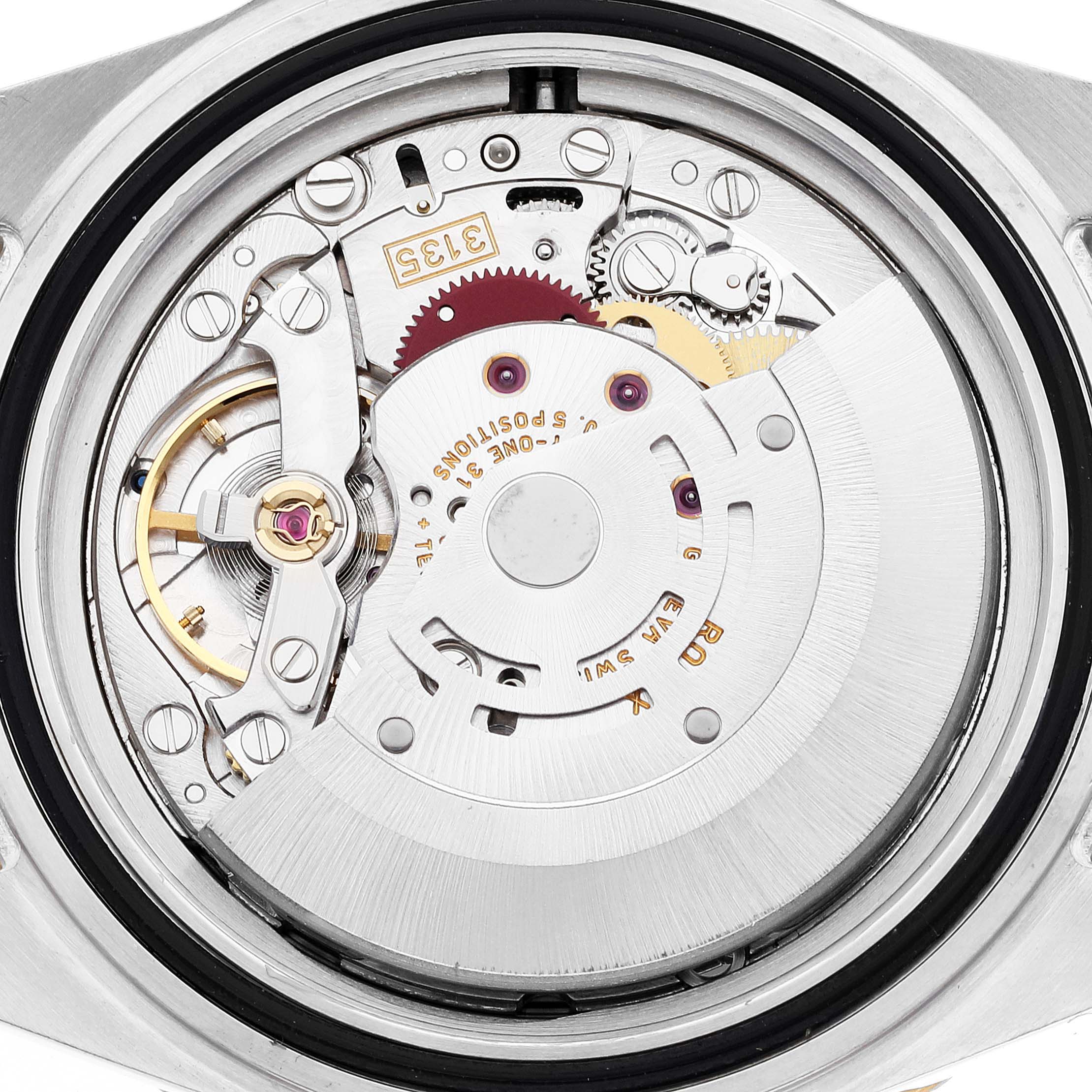 The image shows the intricate internal mechanism of a Rolex Submariner 16613 Men's Steel and Gold (two tone) Blue Dial 16613 Men's Steel and Gold (two tone) Blue Dial watch seen from the back.