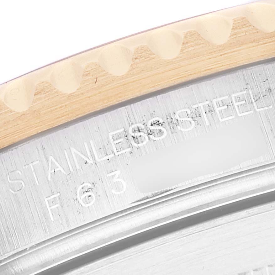 The image shows a close-up angle of the case back and bezel of the Rolex Submariner 16613 Men's Steel and Gold (two tone) Blue Dial 16613 Men's Steel and Gold (two tone) Blue Dial.