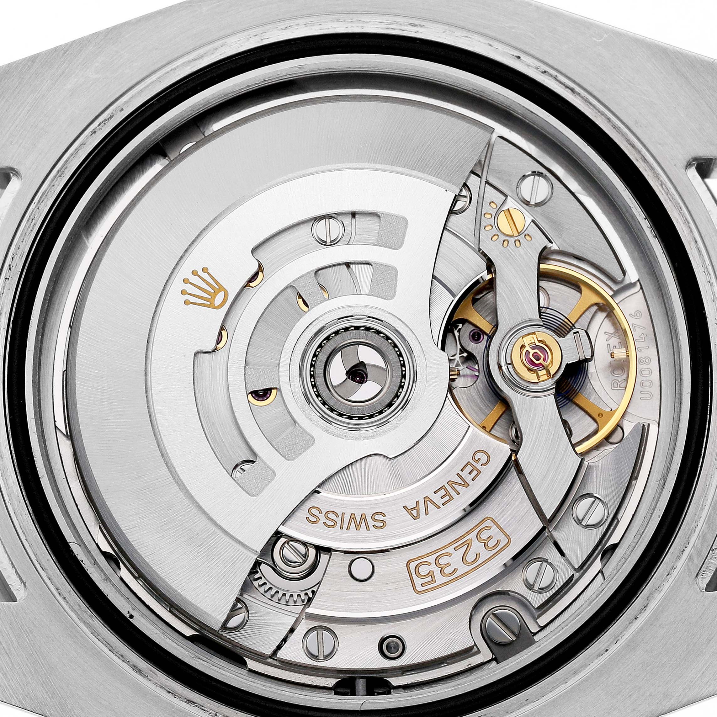 The image shows a close-up of the Rolex Submariner 126610LN Men's Stainless Steel Black Dial's movement, highlighting gears and engravings from a top-down angle.