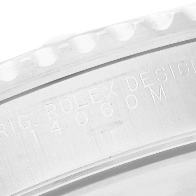 This image shows a close-up of the engraved side of a Rolex Submariner 14060M Men
s Stainless Steel Black Dial 14060M Men
s Stainless Steel Black Dial watch case.