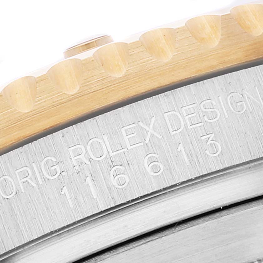 The image shows a close-up of the bezel and edge of the case of a Rolex Submariner 116613 Men's Steel and Gold (two tone) Blue Dial 116613 Men's Steel and Gold (two tone) Blue Dial watch, with model number engraved.