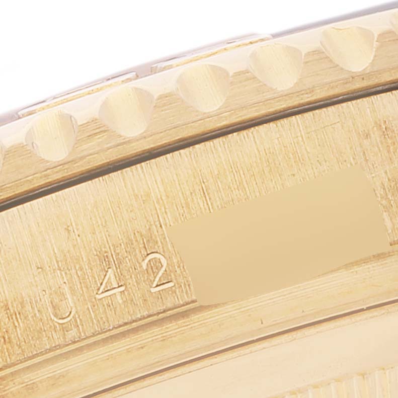 This close-up image shows the bezel and part of the case back of a Rolex Yacht-Master 16628 Men's Yellow Gold White Dial 16628 Men's Yellow Gold White Dial watch.
