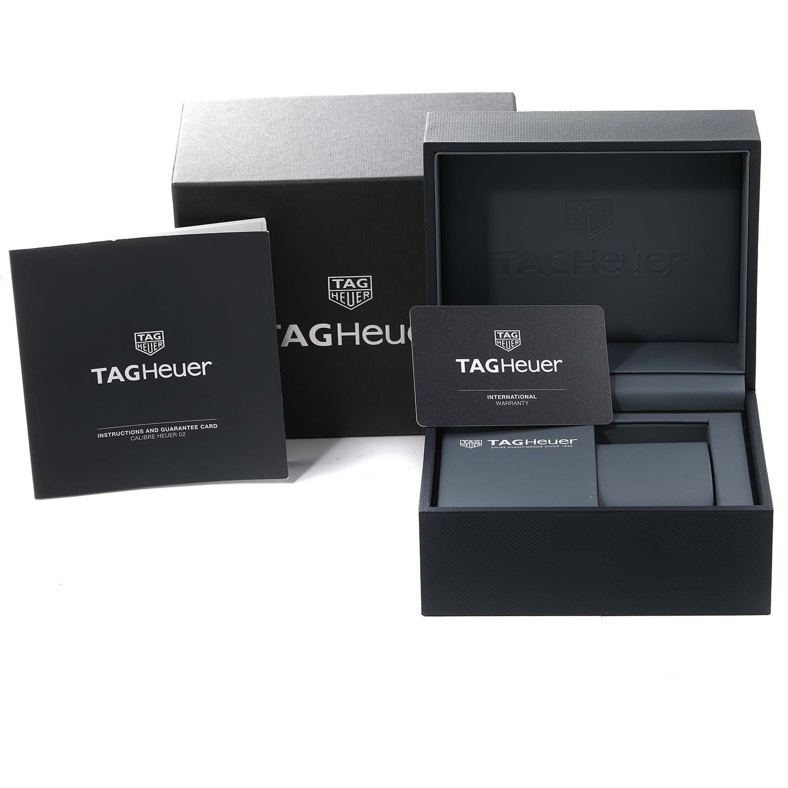 The image shows the packaging, instructions manual, and warranty card of the Tag Heuer Carrera CBG2010 Men's Stainless Steel Black Dial CBG2010 Men's Stainless Steel Black Dial watch.