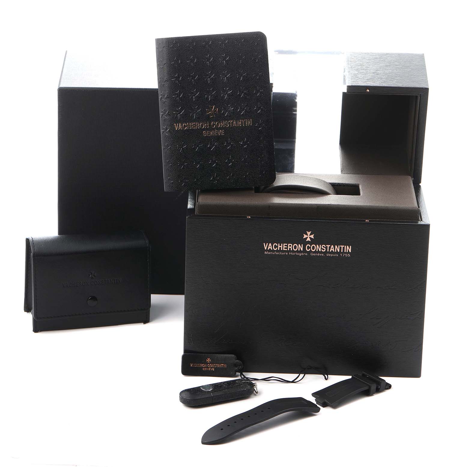 The image shows packaging and accessories for a Vacheron Constantin Overseas model 47040 men's watch, including boxes, booklets, and additional straps.