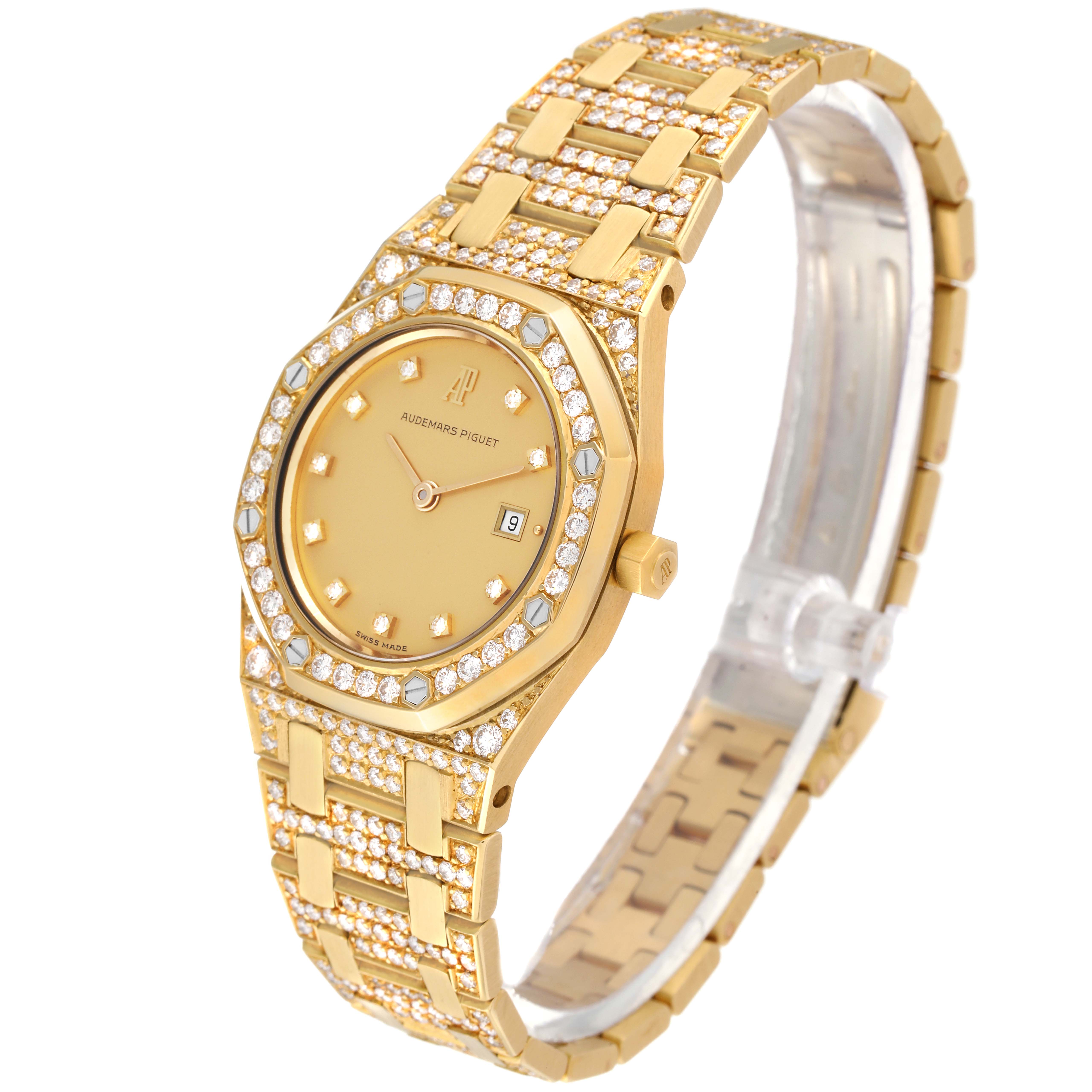 The image shows a gold Audemars Piguet Royal Oak Women's Yellow Gold Champagne Dial Women's Yellow Gold Champagne Dial watch from a 3/4 angle, displaying its bracelet, case, dial, and bezel encrusted with diamonds.
