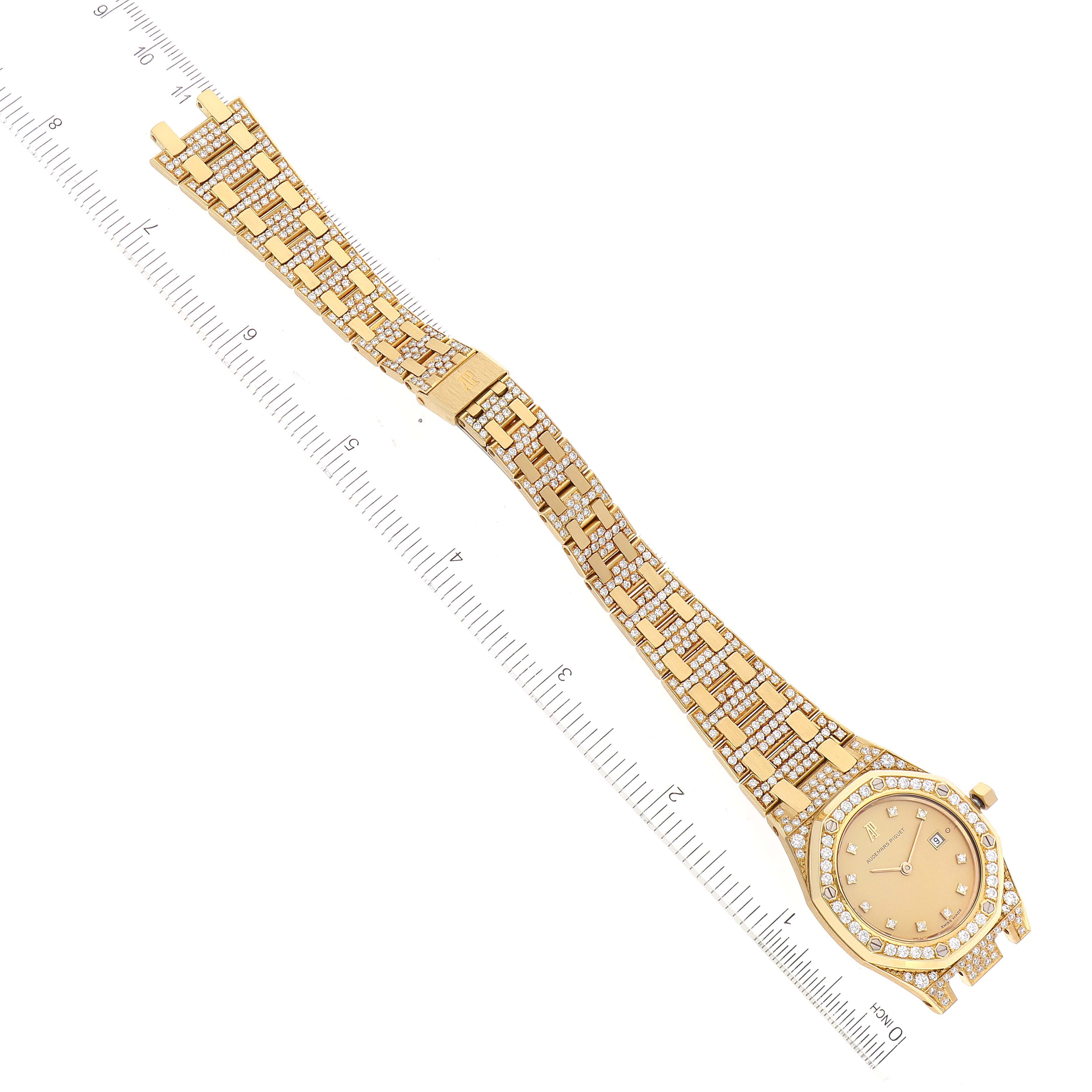 The image shows an Audemars Piguet Royal Oak Women's Yellow Gold Champagne Dial Women's Yellow Gold Champagne Dial watch laid flat at a diagonal angle, highlighting the face, bracelet, and clasp.