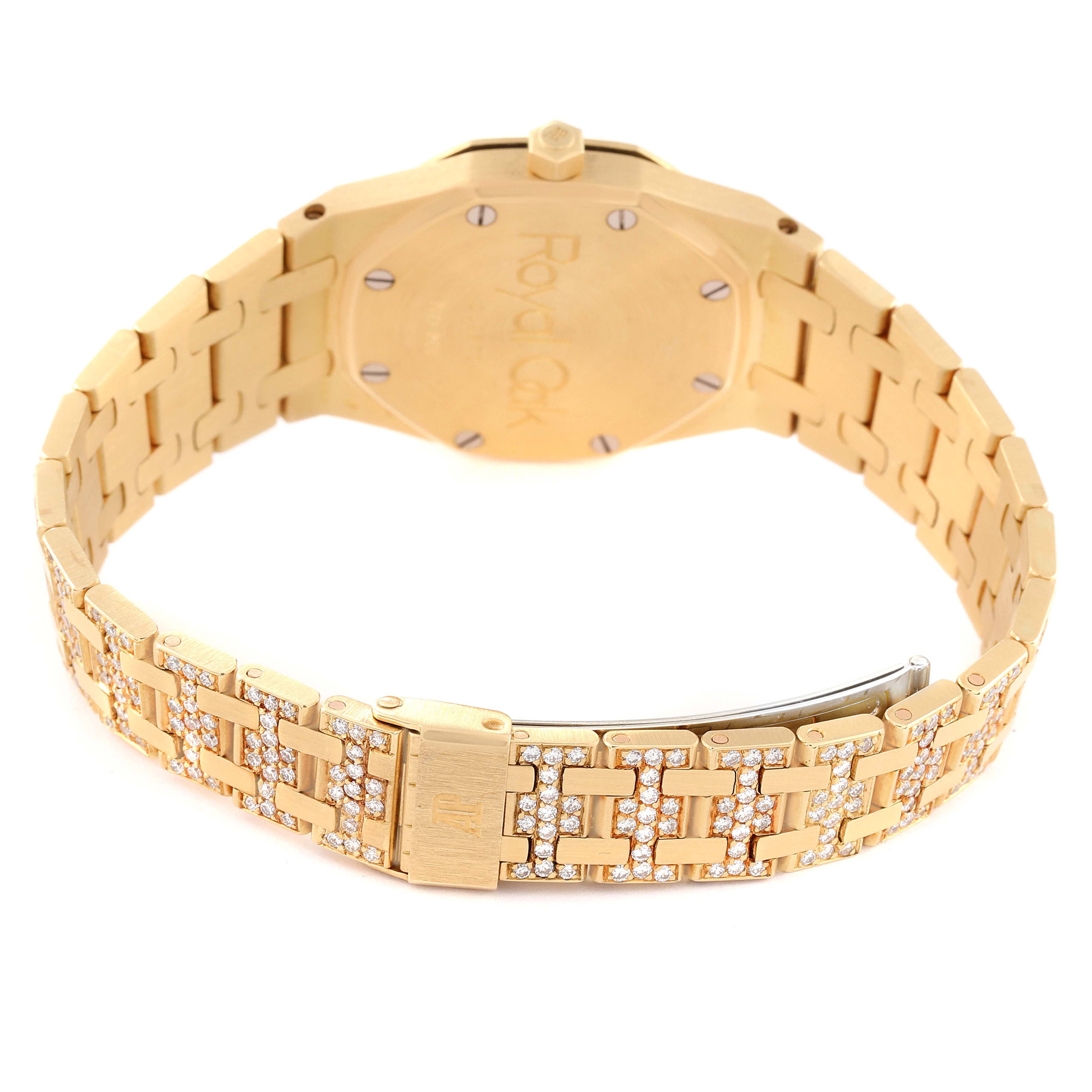 This Royal Oak model by Audemars Piguet is shown from the back, highlighting its gold case and jeweled bracelet.