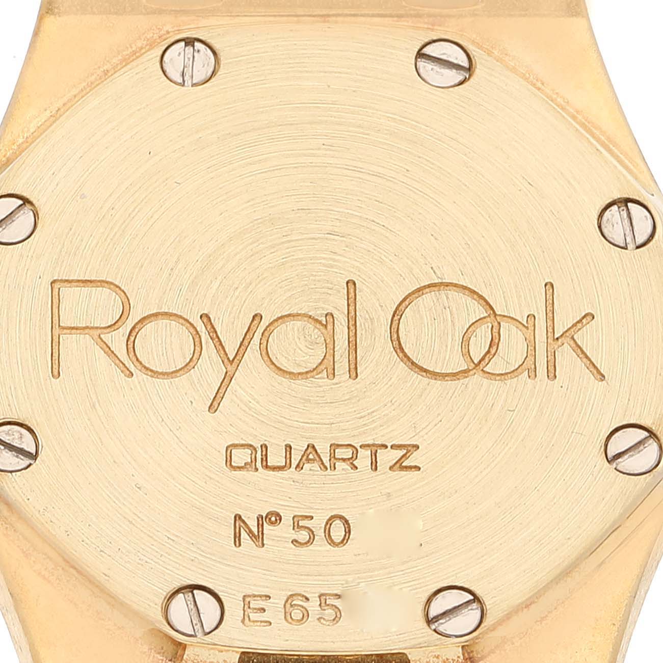 The image shows the back case of an Audemars Piguet Royal Oak 66344BA Women's Yellow Gold Mother of Pearl Dial 66344BA Women's Yellow Gold Mother of Pearl Dial watch, displaying the model name, "Quartz" inscription, and some identification numbers.