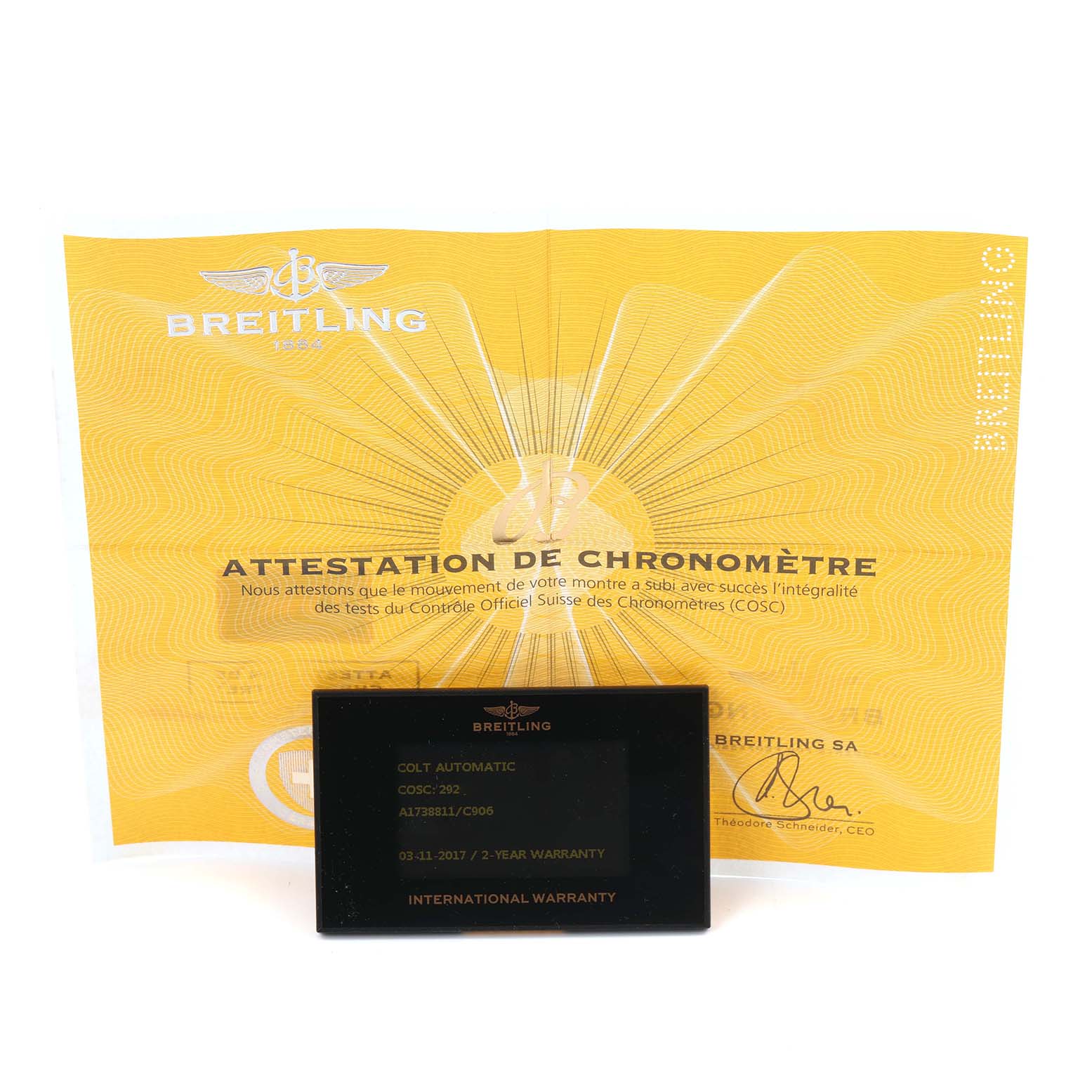 The image shows the warranty card and certification papers for the Breitling Colt, model number A17388, placed upright and viewed from the front.