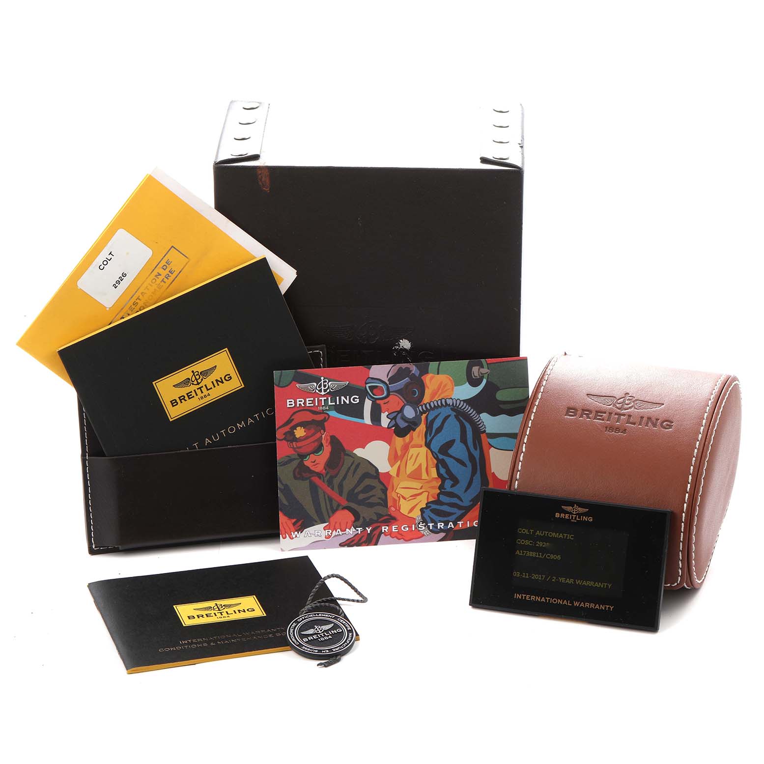 The image shows accessories for the Breitling Colt model A17388, including a box, manuals, warranty cards, and a leather pouch.