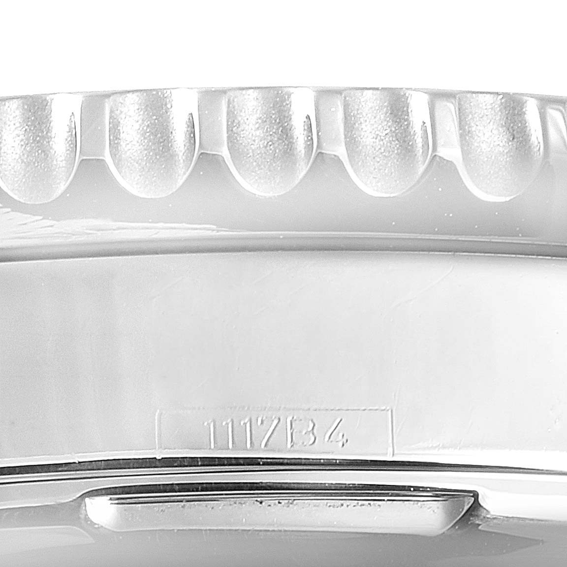 The image shows a close-up of the side view of a Breitling Navitimer AB0120 Men
s Stainless Steel Black Dial AB0120 Men
s Stainless Steel Black Dial watch bezel and case, highlighting its engraved serial number.