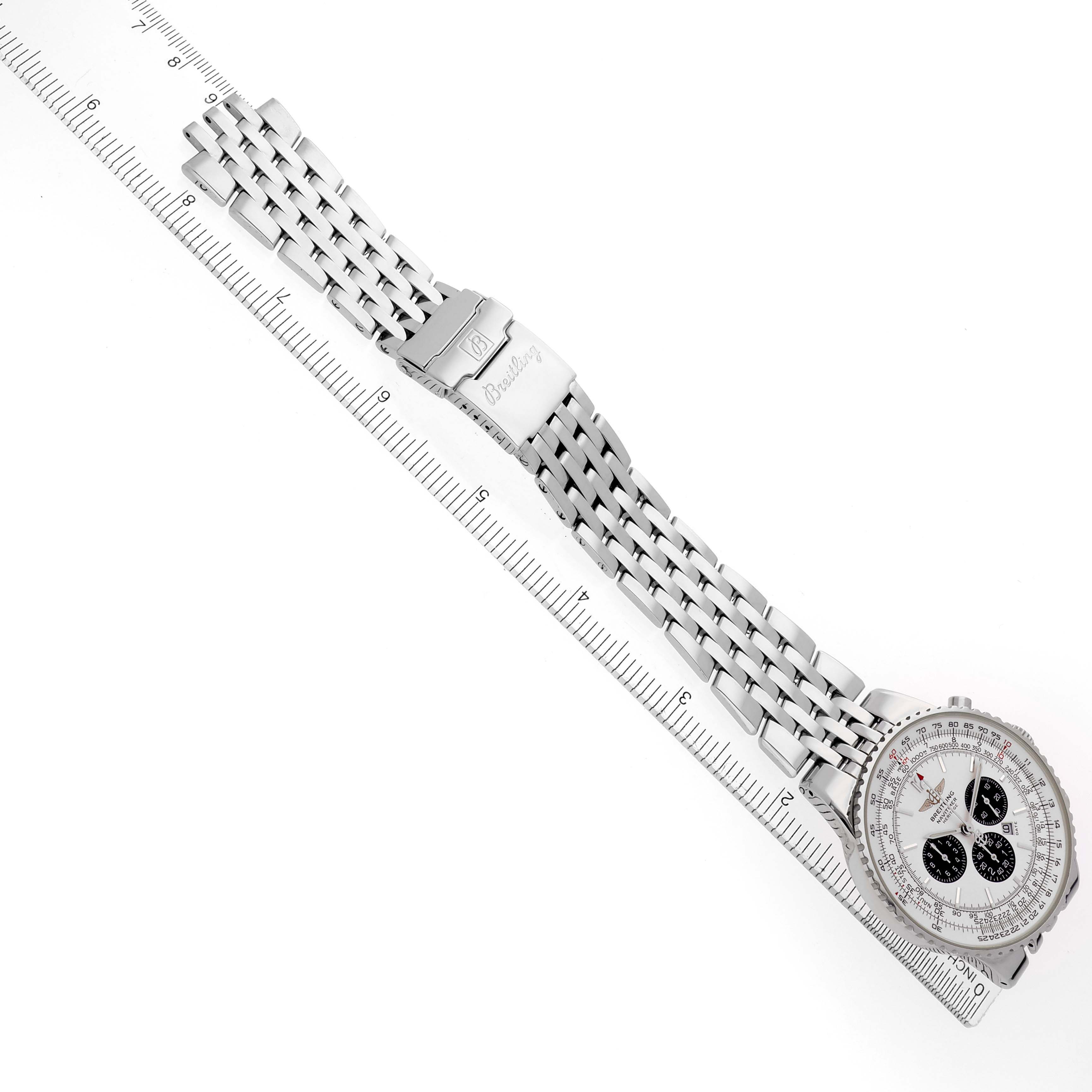 The Breitling Navitimer A35340 watch is shown at an angled top-down view, displaying its face, bezel, bracelet, and clasp aligned with a ruler for scale.