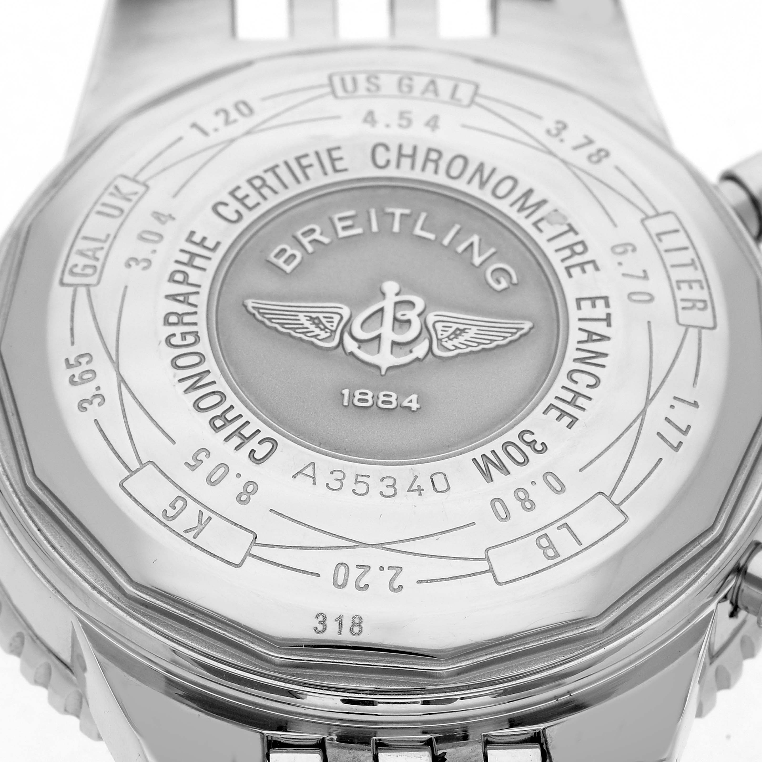 The image shows the back of a Breitling Navitimer, model A35340, displaying its engravings and conversion scale from a close-up angle.