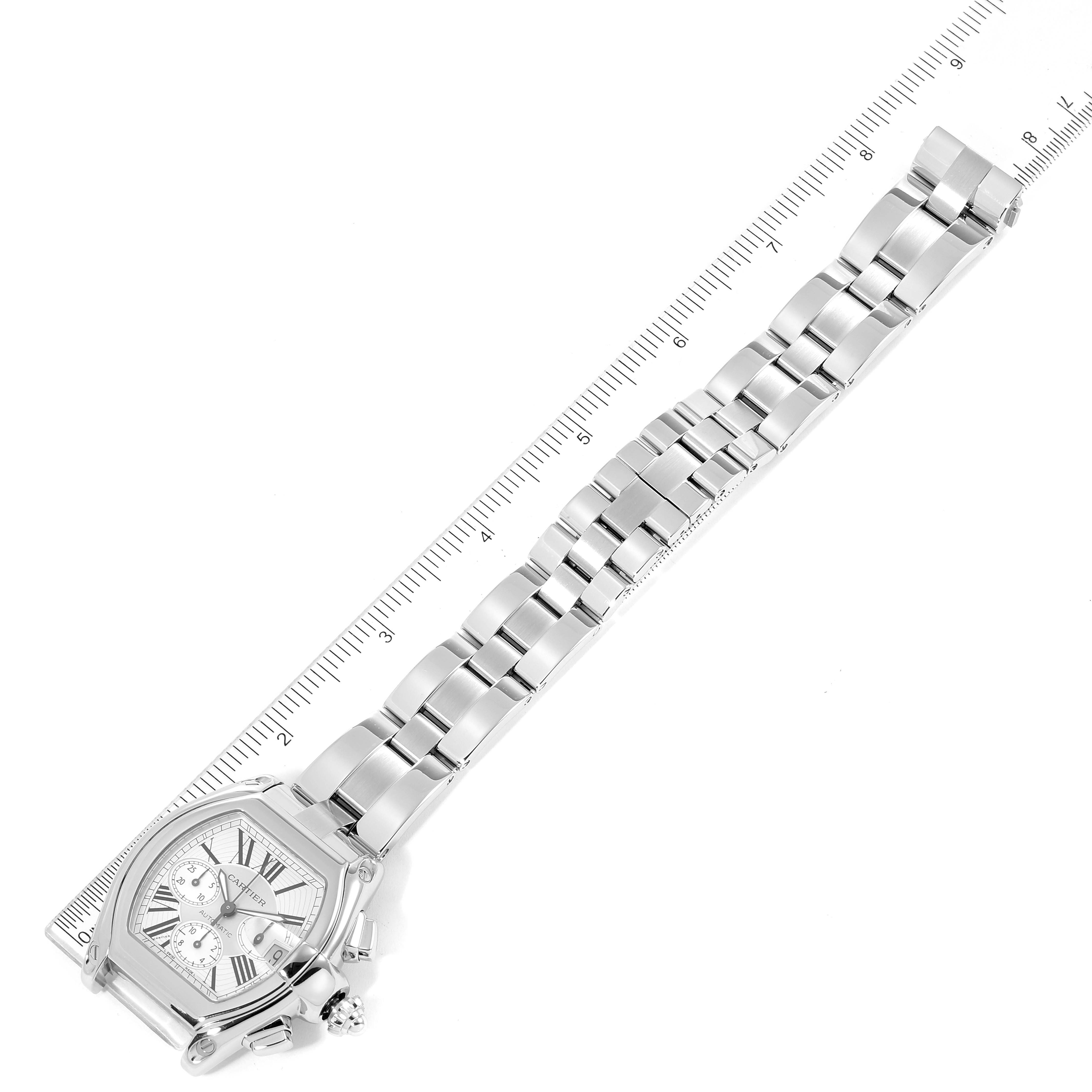 This image shows a Cartier Roadster W62019X6 Men
s Stainless Steel Silver Dial W62019X6 Men
s Stainless Steel Silver Dial watch laid flat, with the face and full metal strap visible, measured against a ruler.