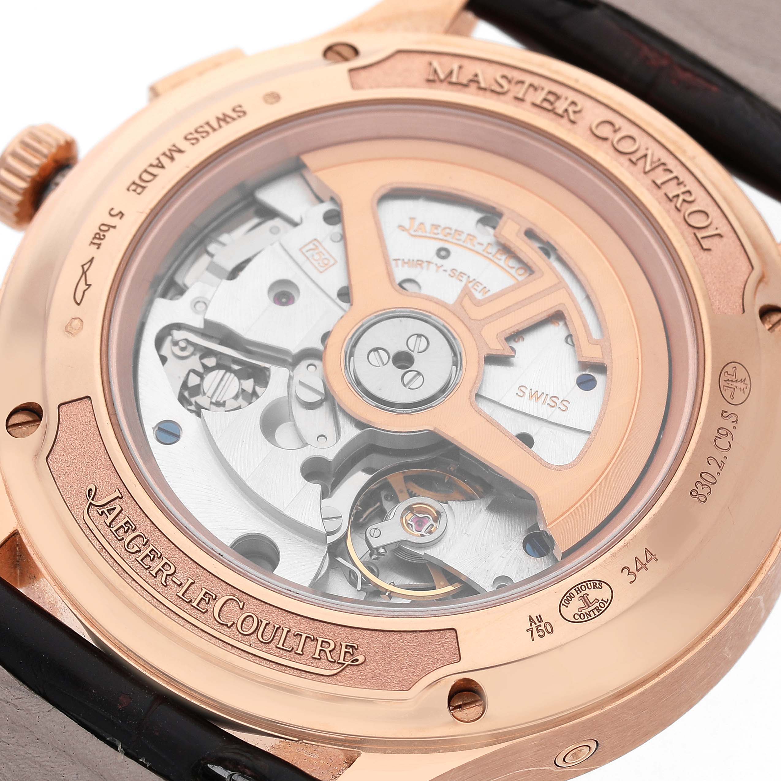 The Jaeger LeCoultre Master Q4132520 Men's Rose Gold Silver Dial model is shown from the back, highlighting its movement and rotor mechanism.