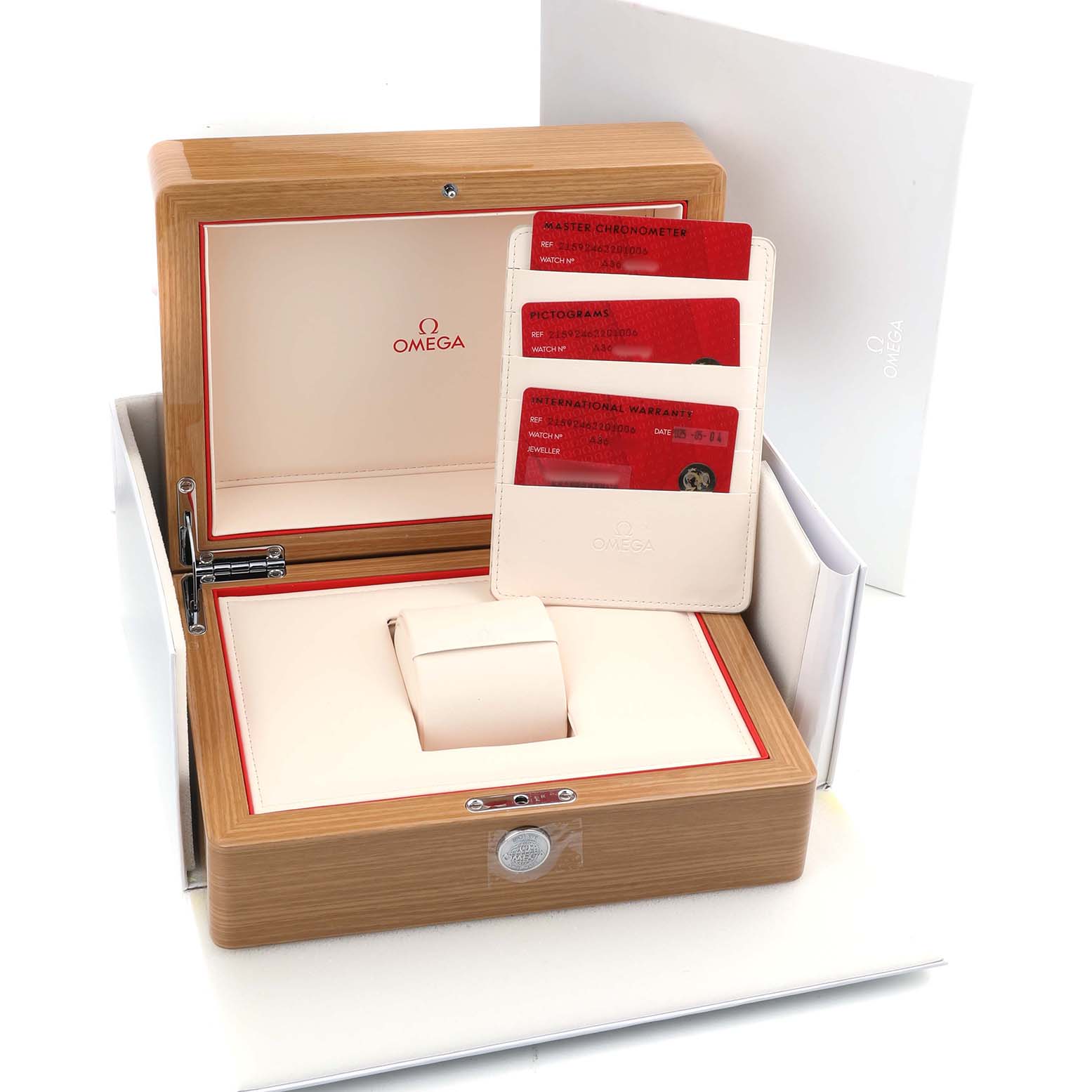 The image shows an Omega Planet Ocean 215.92.46.22.01.006 Men's Ceramic Black Dial watch box, warranty cards, and a cardholder from a top angle.