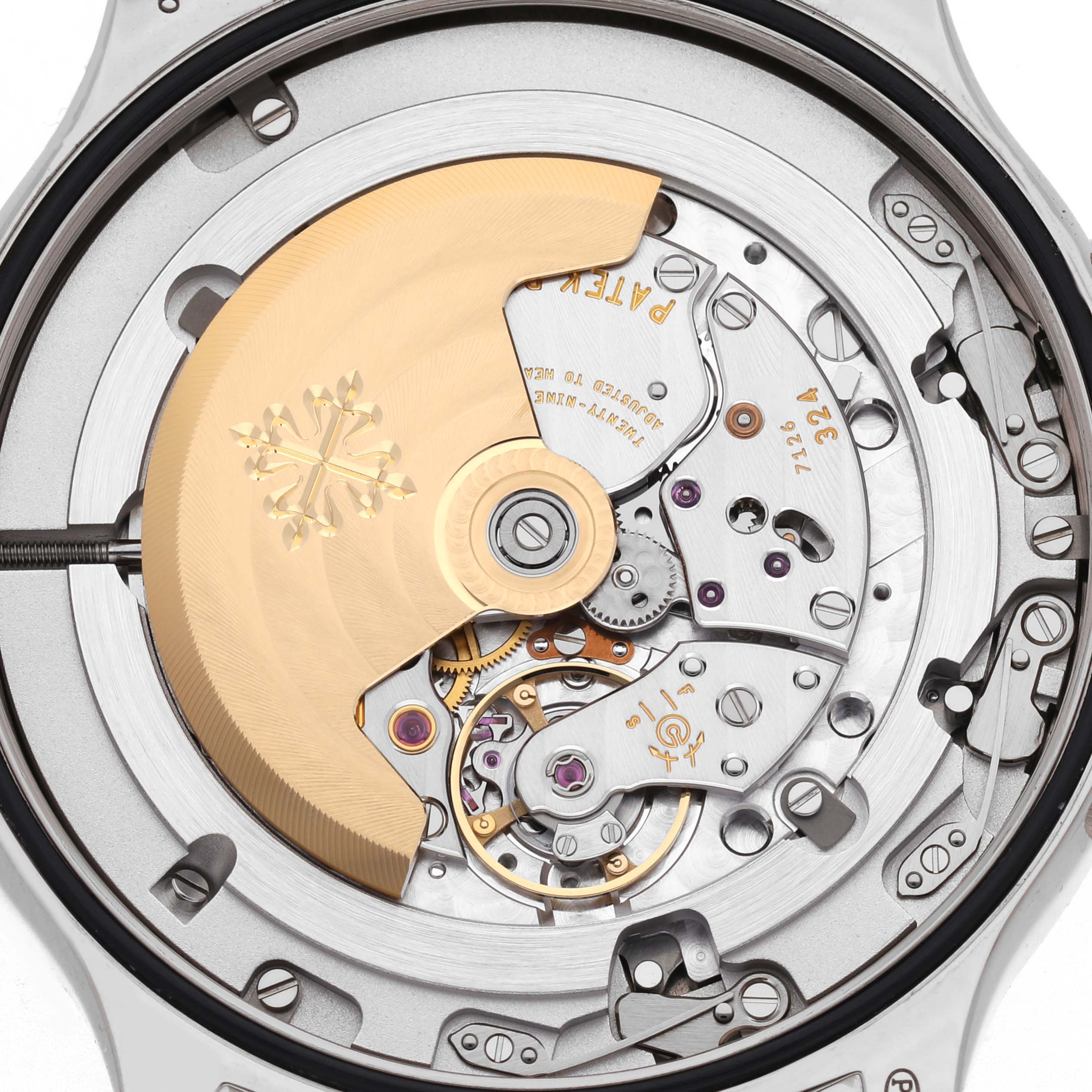 The image shows the back view of a Patek Philippe Calatrava model 5524G-001, highlighting its intricate mechanical movement and gold rotor.
