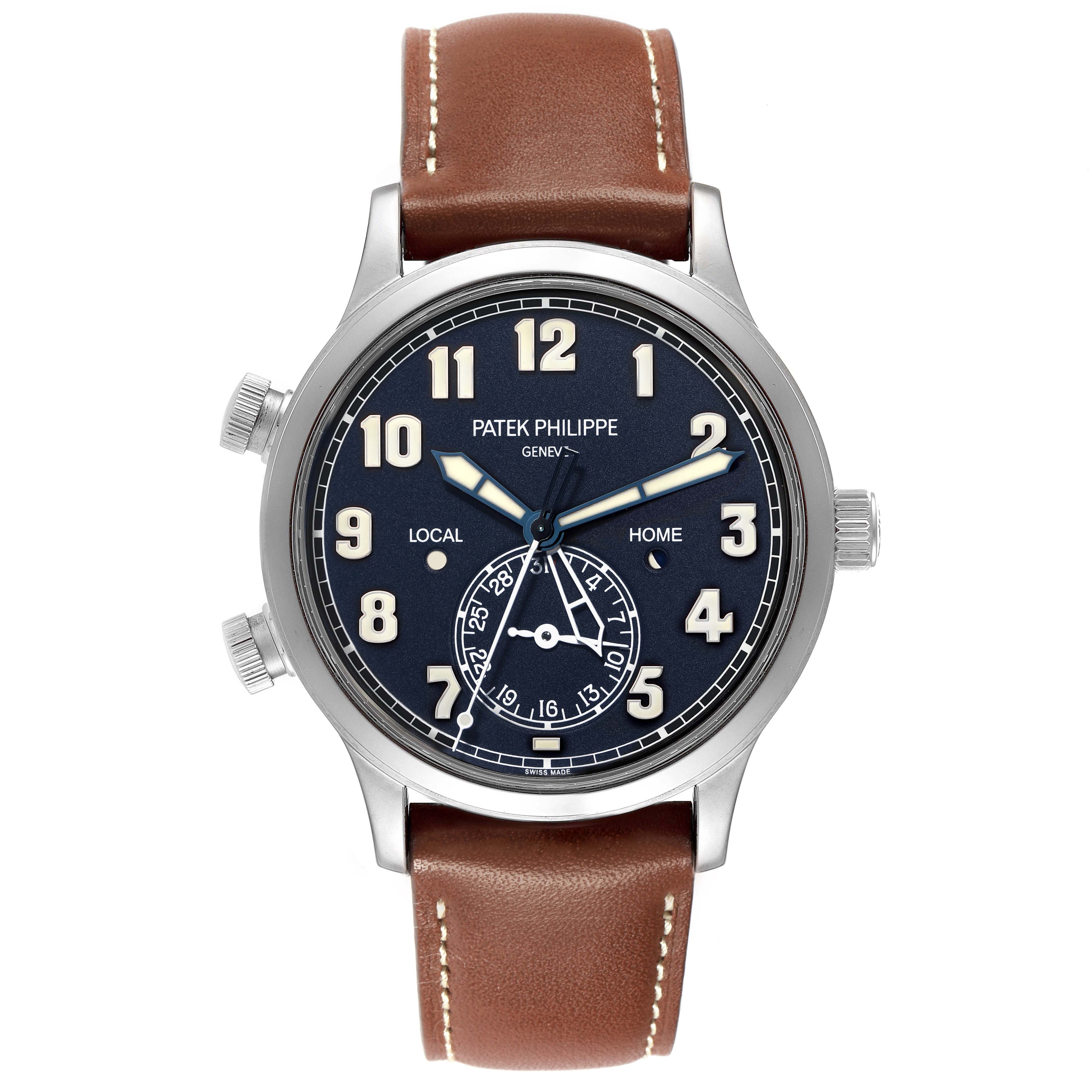 The image shows a Patek Philippe Calatrava model 5524G-001 men
s watch from a straight-on angle, featuring a blue dial, large numerals, and brown leather strap.