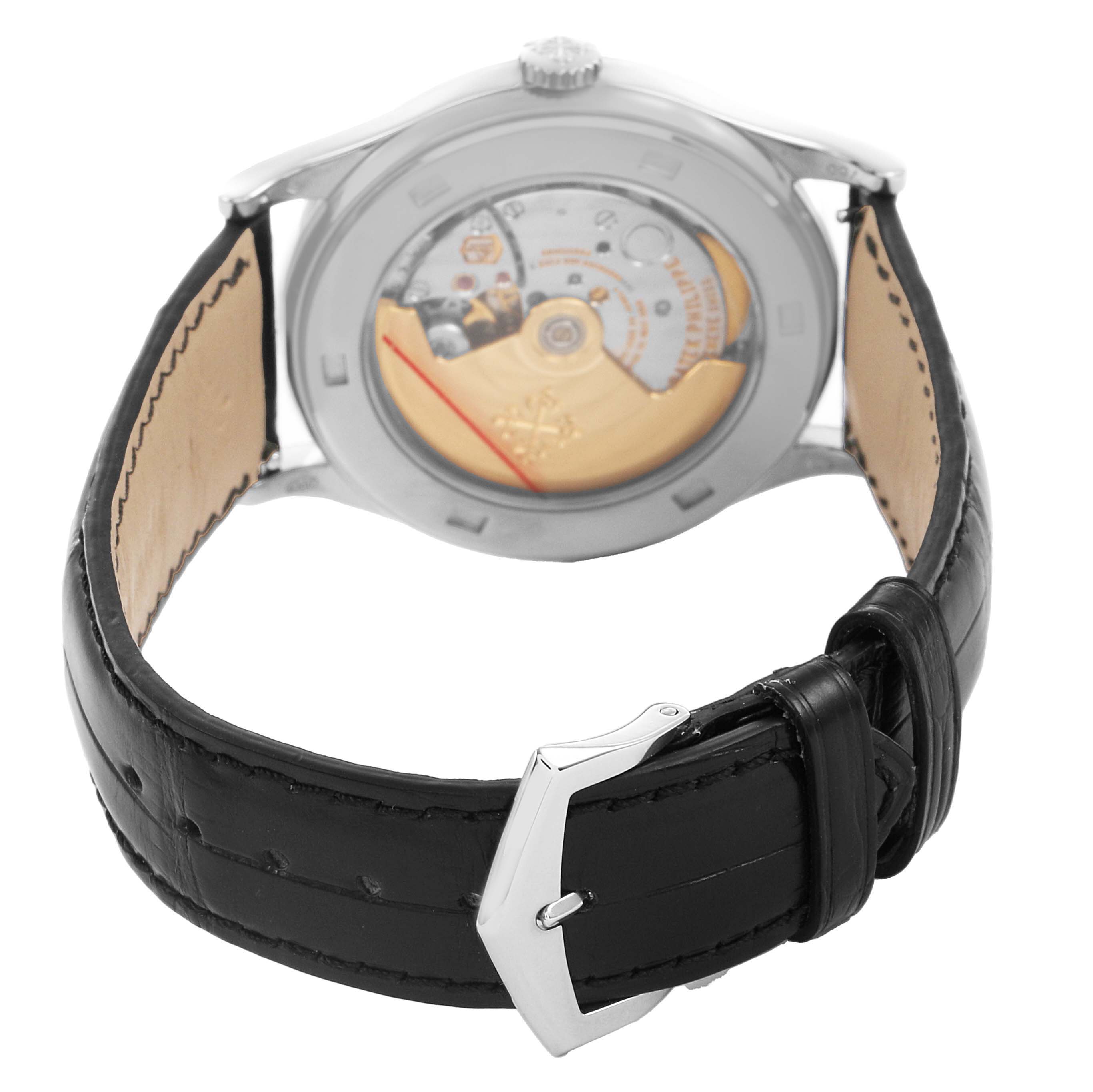 The Patek Philippe Calatrava 5296G-010 Men's White Gold Silver Dial watch is shown from a rear angle, highlighting its exposed movement and black leather strap with a buckle.