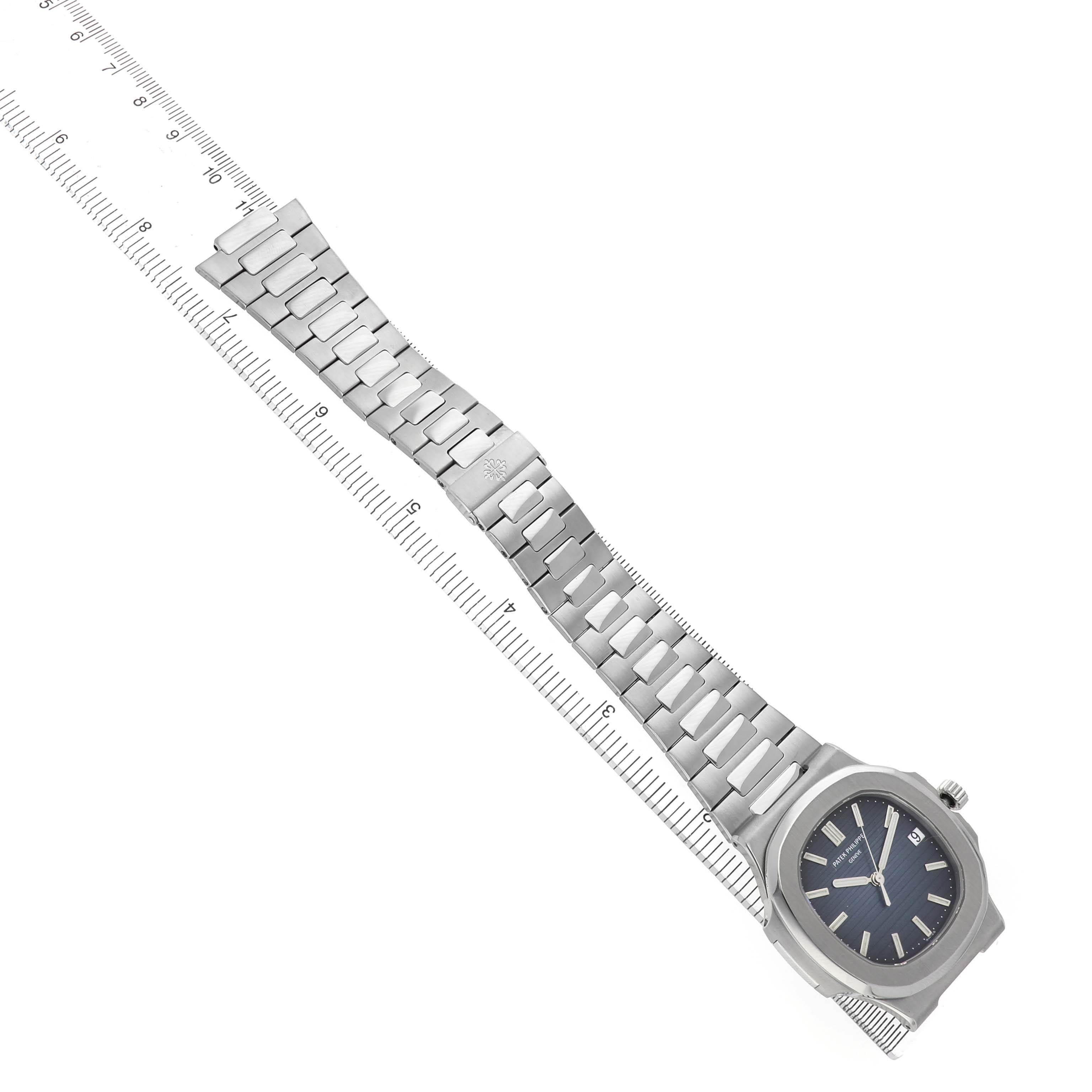 The image shows a Patek Philippe Nautilus 5711/1A-001 Men's Stainless Steel Blue Dial watch from a top-down angle, displaying the dial and full metal bracelet.
