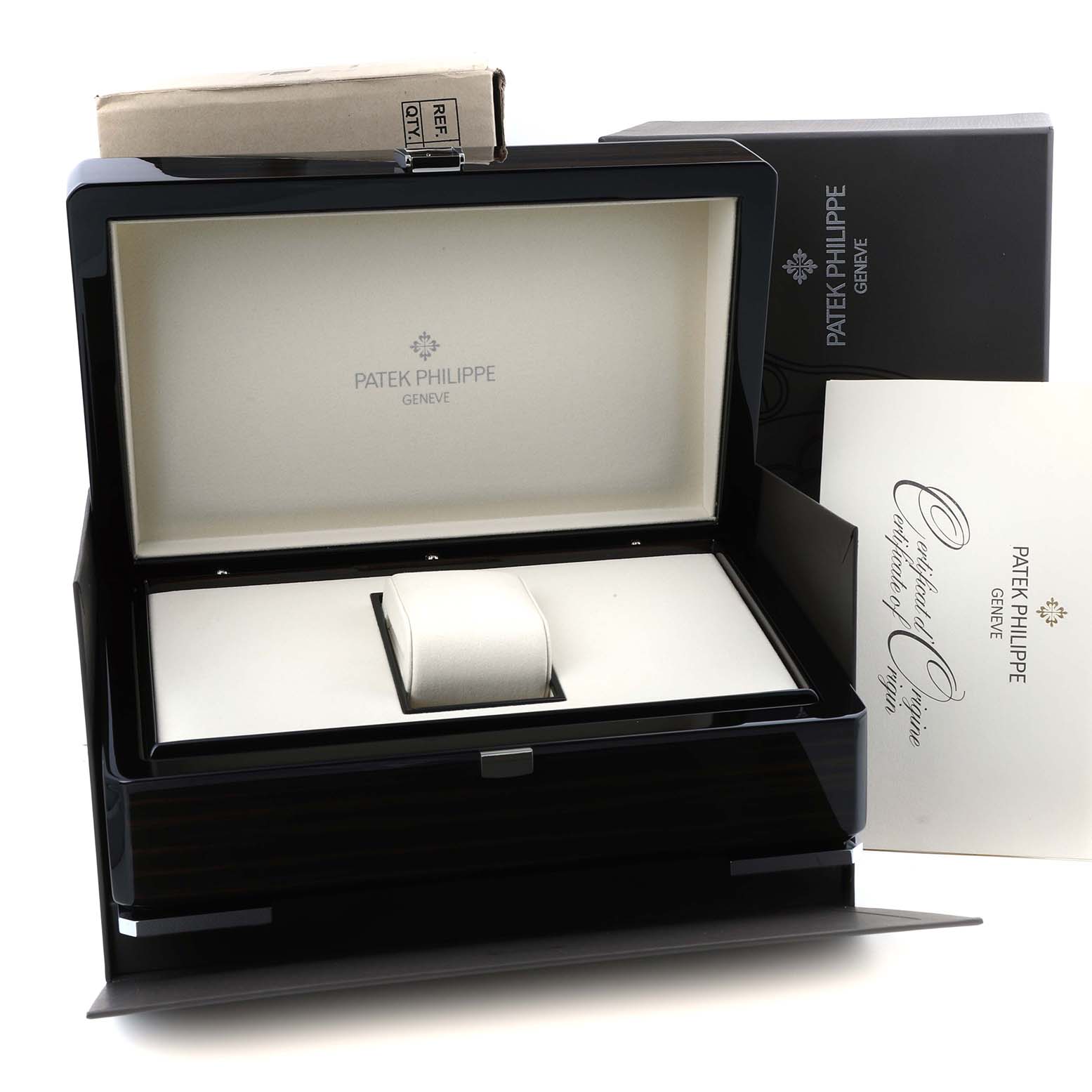 The image shows a Patek Philippe Nautilus 5711/1A-001 Men's Stainless Steel Blue Dial watch box, with the lid open, displaying a cushion and certificate of origin.