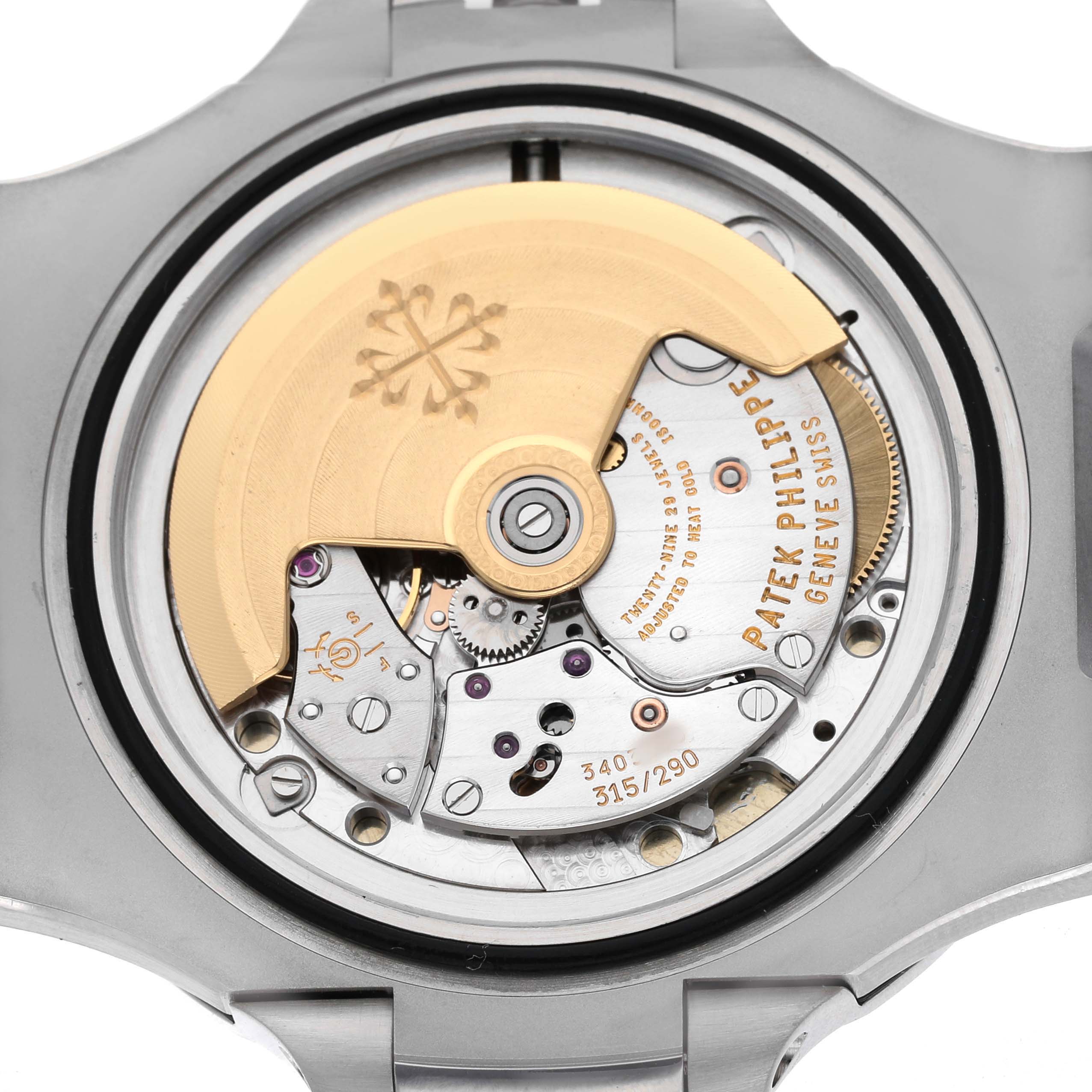The image shows the back view of a Patek Philippe Nautilus 5711/1A-001 Men's Stainless Steel Blue Dial watch, highlighting the intricate movement and rotor.