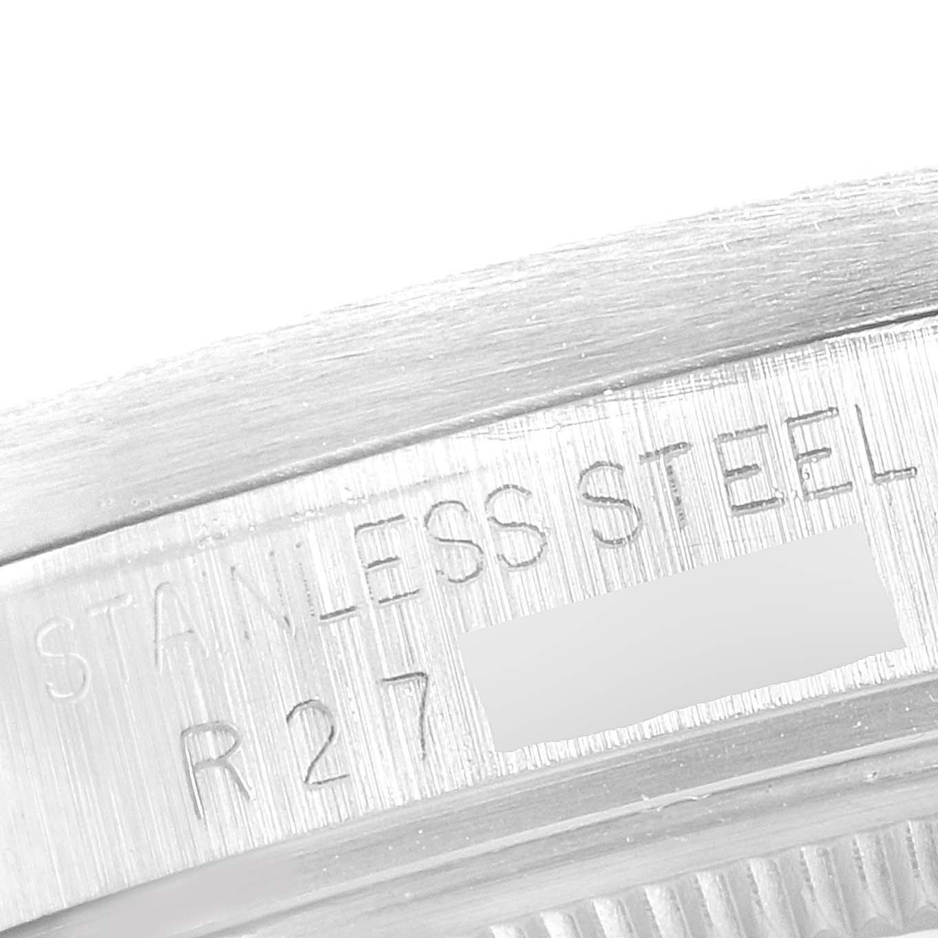 This image shows a close-up of the stainless steel case back with engravings on a Rolex Date 15010 Men's Stainless Steel Silver Dial 15010 Men's Stainless Steel Silver Dial model watch.