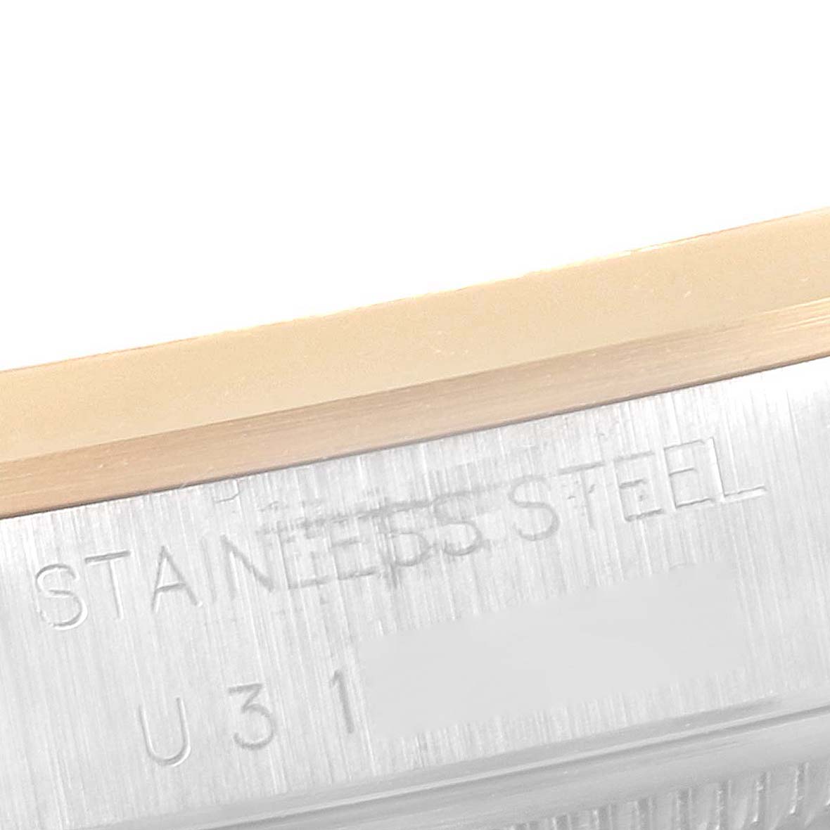 This image shows a close-up shot of the side of a Rolex Date 15203 Men's Steel and Gold (two tone) Black Dial 15203 Men's Steel and Gold (two tone) Black Dial model watch, displaying the serial number and part of the stainless steel casing.