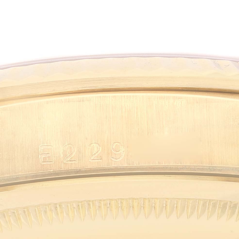 The image shows a close-up of the side of a Rolex Datejust 16238 Men's Yellow Gold Champagne Dial 16238 Men's Yellow Gold Champagne Dial watch case, highlighting engraved numbers and part of the bezel.