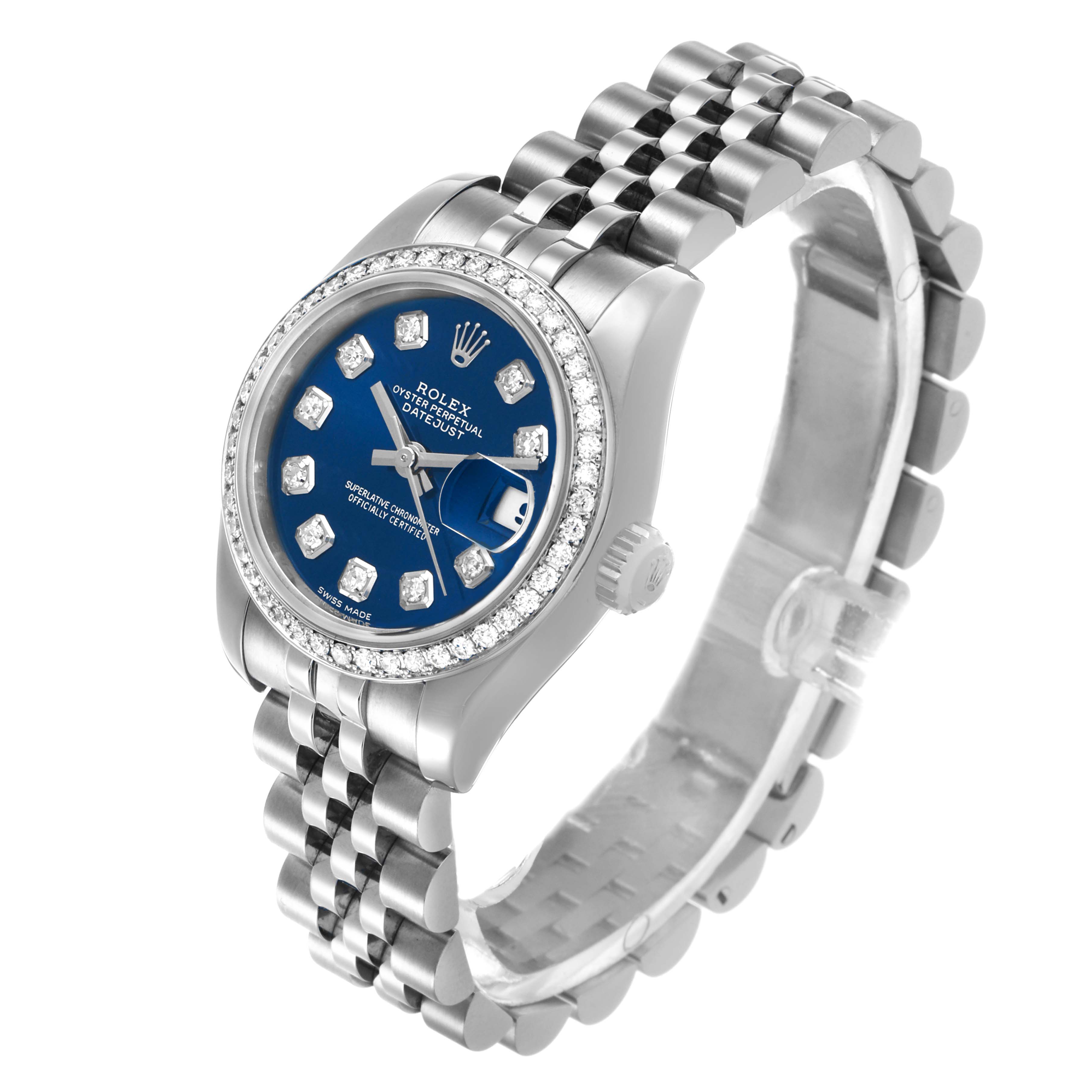 The Rolex Datejust 179384 Women's Stainless Steel Blue Dial watch is shown at a three-quarter angle displaying the blue dial, diamond hour markers, and jubilee bracelet.