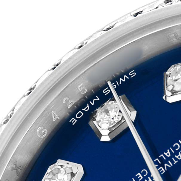 The image shows a close-up of the blue dial, diamond indices, and a portion of the bezel of a Rolex Datejust 179384 Women's Stainless Steel Blue Dial watch.